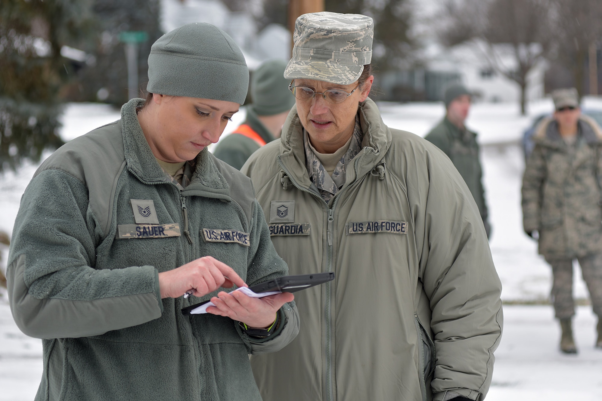 Tech Sgt. Jennifer Sauer and Master Sgt. C.K. Laguardia, both members of the Michigan Air National Guard, review the day’s operations during water delivery efforts in Flint, Mich., Jan. 21, 2016. Selfridge Air National Guard Base has served as a hub for water distribution efforts in Flint. Sauer is assigned to the 127th Wing at Selfridge. Laguardia is a member of the 110th Attack Wing in Battle Creek. (U.S. Air National Guard photo)