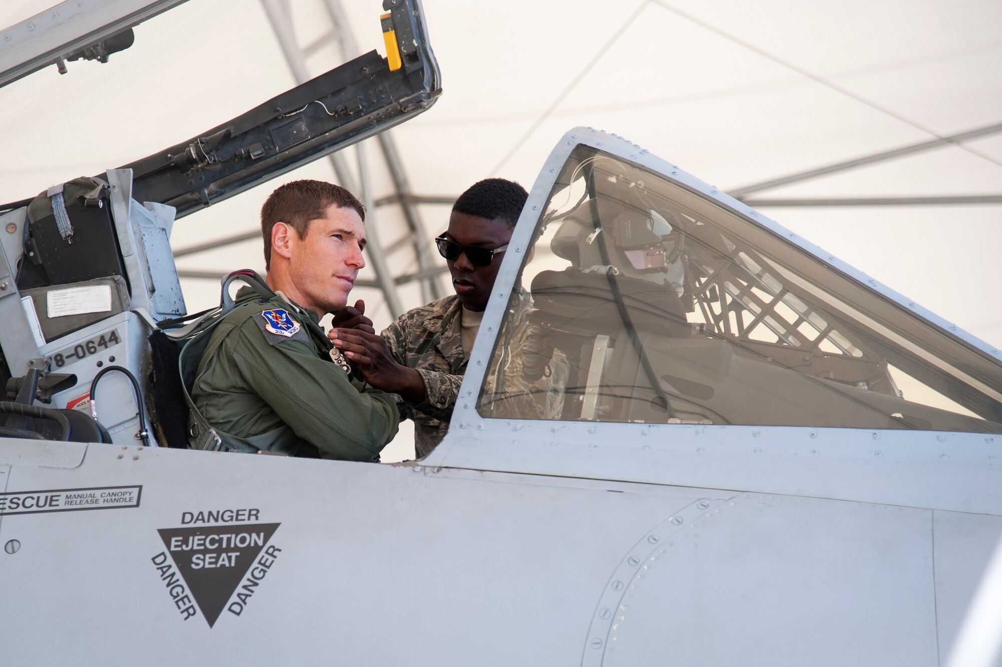 U.S. Air Force Airman 1st Class Deandre Black, 23d Aircraft Maintenance Squadron crew chief, assists Lt. Col. Dustin Ireland, 23d Wing director of staff, during a preflight inspection, Feb. 18, 2016, at Moody Air Force Base, Ga. Multiple U.S. Air Force aircraft within Air Combat Command conducted joint aerial training at Grand Bay Bombing and Gunnery Range. During the training, the aircraft conducted tactical air and ground maneuvers, as well as weapons training. (U.S. Air Force photo by Andrea Jenkins/Released)