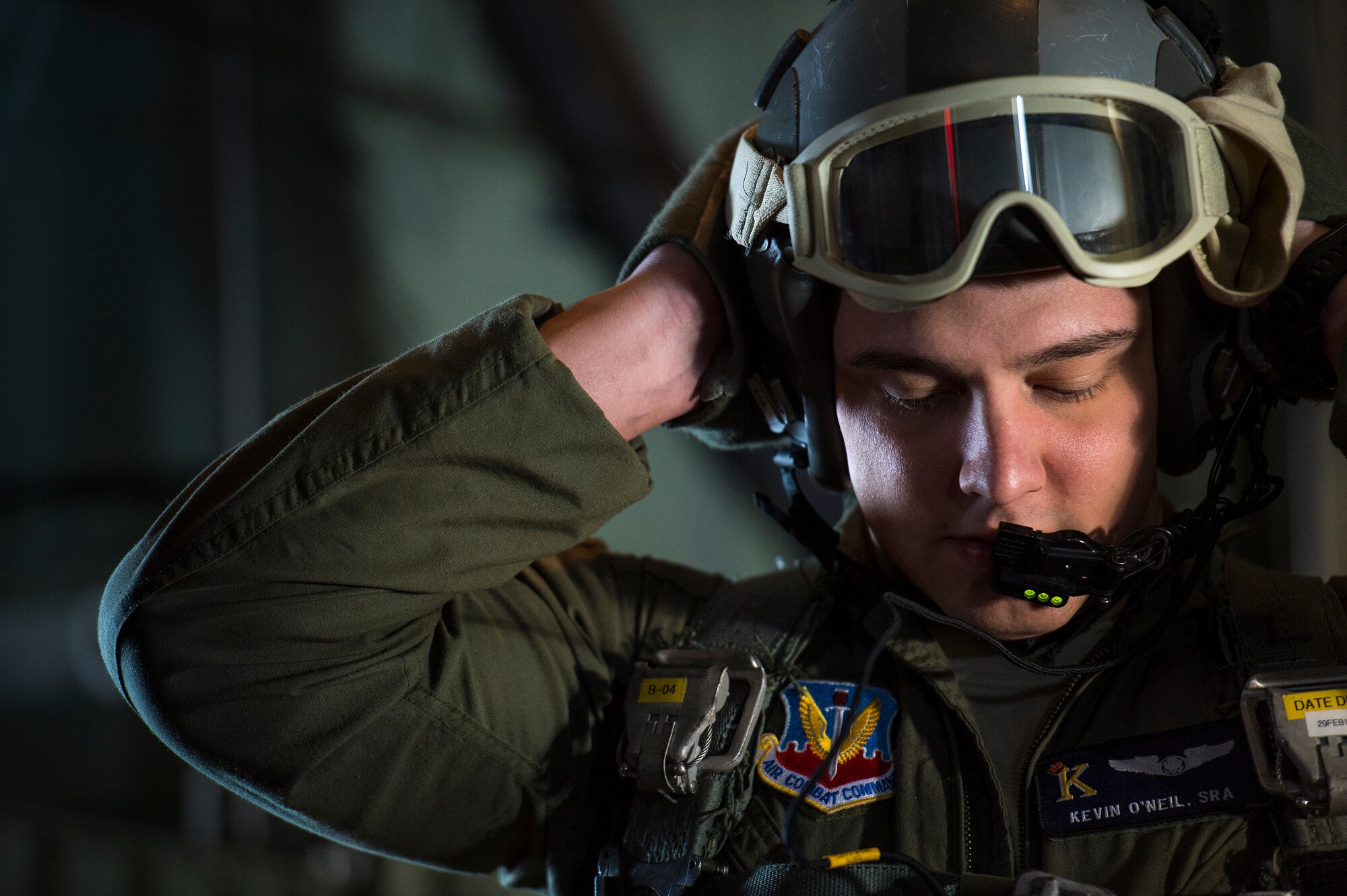 U.S. Air Force Senior Airman Kevin O’Neil, 71st Rescue Squadron loadmaster, adjusts his helmet prior to conducting personnel drops from an HC-130J Combat King II, Feb. 18, 2016, in the skies over South Ga.  Multiple U.S. Air Force aircraft within Air Combat Command conducted joint aerial training at Grand Bay Bombing and Gunnery Range. During the training, the aircraft conducted tactical air and ground maneuvers, as well as weapons training. (U.S. Air Force photo by Senior Airman Ryan Callaghan/Released)

