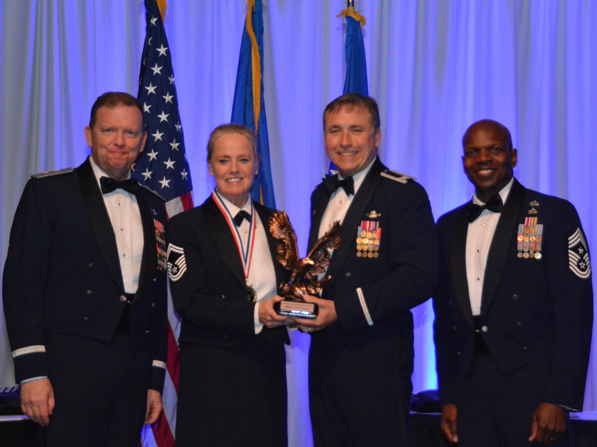 NAVAL AIR STATION FORT WORTH JOINT RESERVE BASE, Texas – Senior Master Sgt. Theresa Furbush, 301st Fighter Wing financial management office, accepts the 2015 Henry D. Green award from Col. John Breazeale, 301st Fighter Wing commander, Feb. 20 at the Fort Worth Stockyards, Texas. Furbush was honored for her outstanding volunteer work in the community at this year’s Annual Awards Banquet. (U.S. Air Force photo by Staff Sgt. Samantha Mathison)