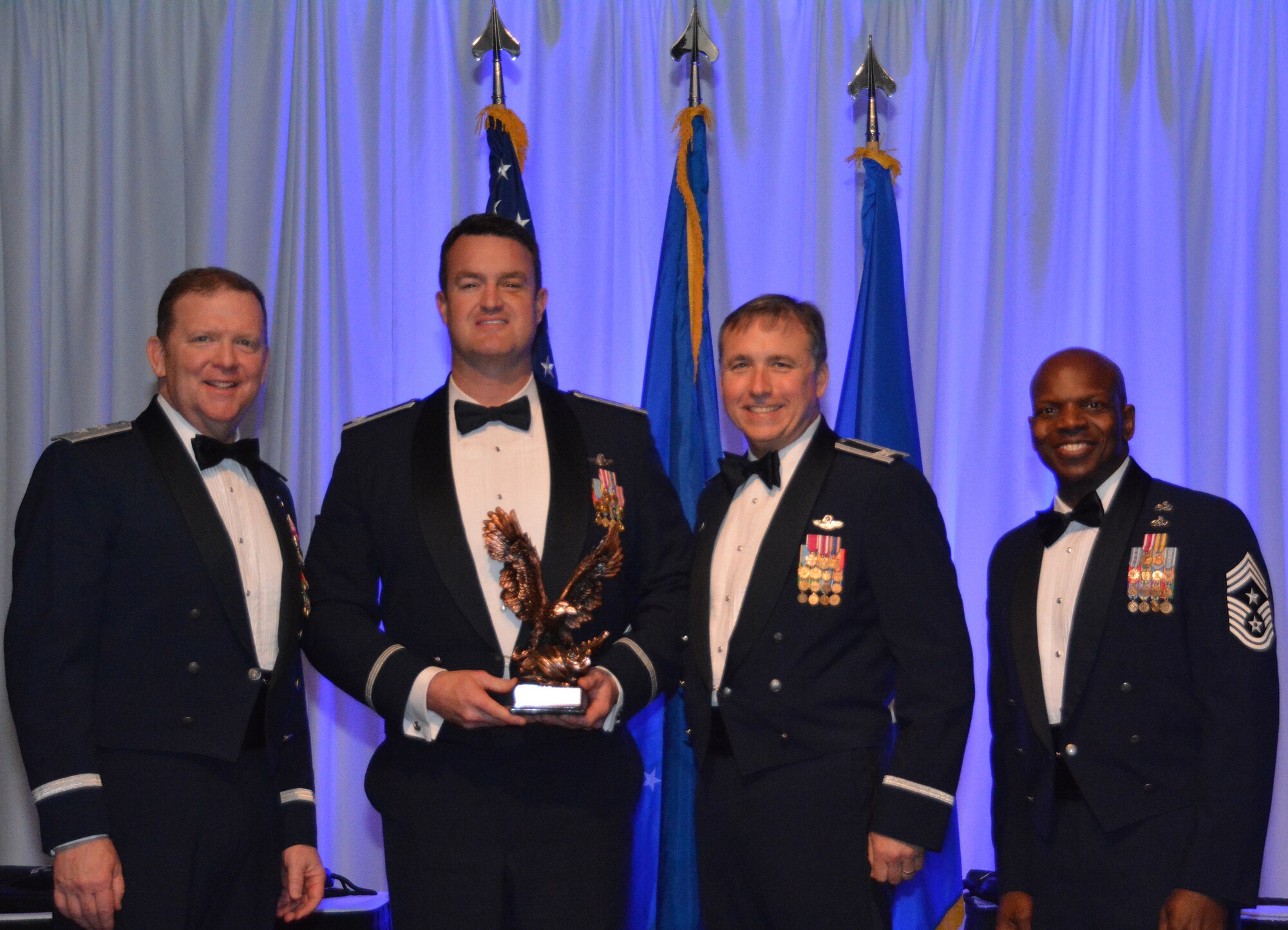 NAVAL AIR STATION FORT WORTH JOINT RESERVE BASE, Texas – Lt. Col. Bryan Dick, 44th Fighter Group, Tyndall Air Force Base, Fla., a geographically-separated unit, accepts the 2015 Field Grade Officer of the Year award from Col. John Breazeale, 301st Fighter Wing commander, Feb. 20 at the Fort Worth Stockyards, Texas. Thirty-four nominees competed in 10 categories for recognition and winners will compete at the major command level. (U.S. Air Force photo by Staff Sgt. Samantha Mathison)