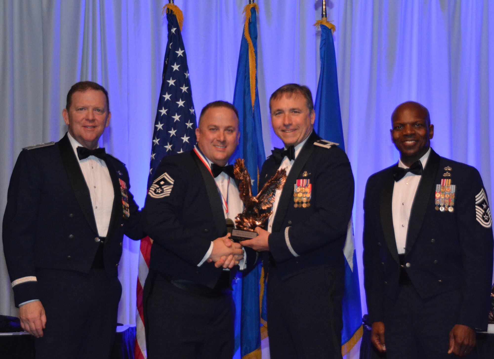 NAVAL AIR STATION FORT WORTH JOINT RESERVE BASE, Texas – Senior Master Sgt. Steven Purvis, 301st Aircraft Maintenance Squadron first sergeant, accepts the 2015 First Sergeant of the Year award from Col. John Breazeale, 301st Fighter Wing commander, Feb. 20 at the Fort Worth Stockyards, Texas. Purvis was publicly recognized for outstanding service during the Annual Awards Banquet hosted by the 301st Fighter Wing. (U.S. Air Force photo by Staff Sgt. Samantha Mathison)