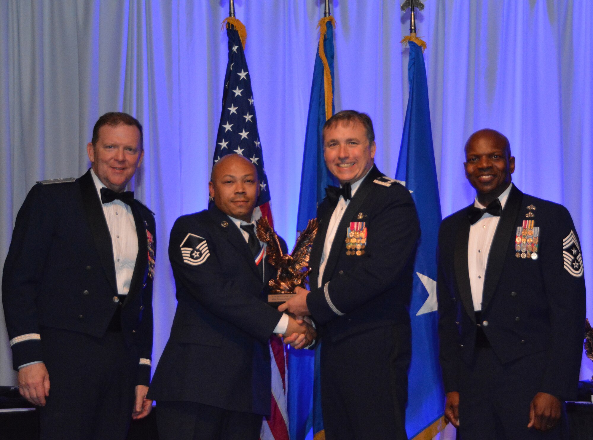 NAVAL AIR STATION FORT WORTH JOINT RESERVE BASE, Texas – Master Sgt. Terrance Calhoun, 44th Fighter Group, Tyndall Air Force Base, Fla., a geographically-separated unit, accepts the 2015 Senior Noncommissioned Officer of the Year award from Col. John Breazeale, 301st Fighter Wing commander, Feb. 20 at the Fort Worth Stockyards, Texas. Many of the winners were honored and will soon compete at the major command level. (U.S. Air Force photo by Staff Sgt. Samantha Mathison)