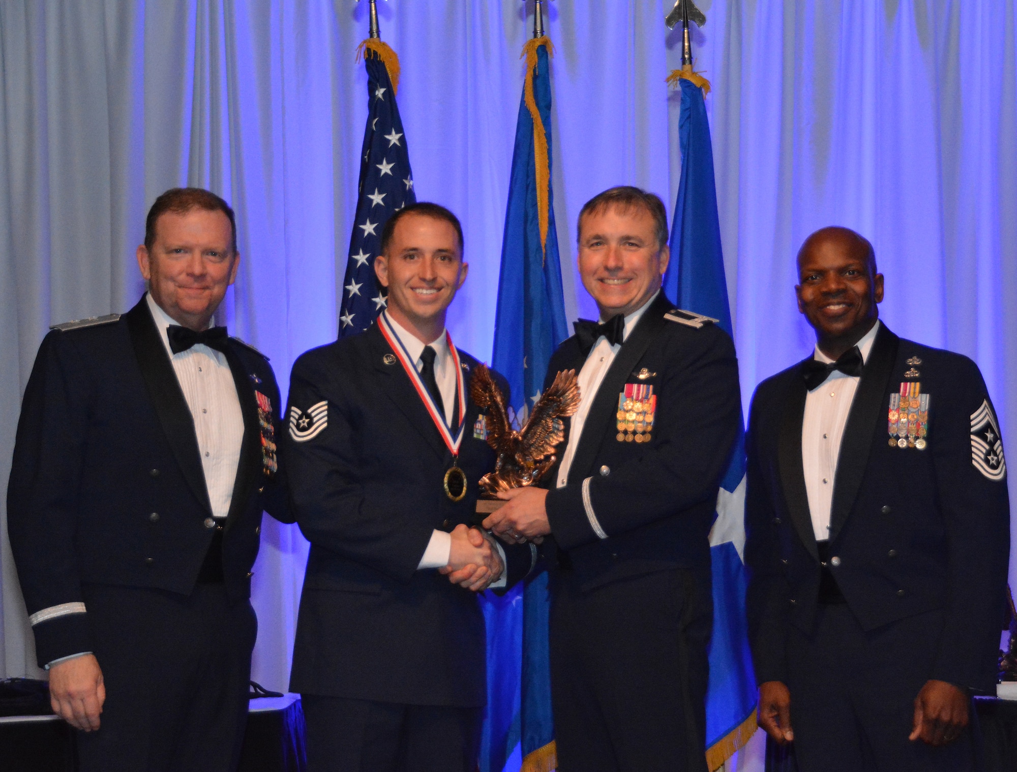 NAVAL AIR STATION FORT WORTH JOINT RESERVE BASE, Texas –Tech. Sgt. Rudy Panacci, 301st Operations Support Flight quality assurance, accepts the 2015 Noncommissioned Officer of the Year award from Col. John Breazeale, 301st Fighter Wing commander, Feb. 20 at the Fort Worth Stockyards, Texas. This is the second year in a row an NCO from the 301 OSF received this award for excellence. (U.S. Air Force photo by Staff Sgt. Samantha Mathison)