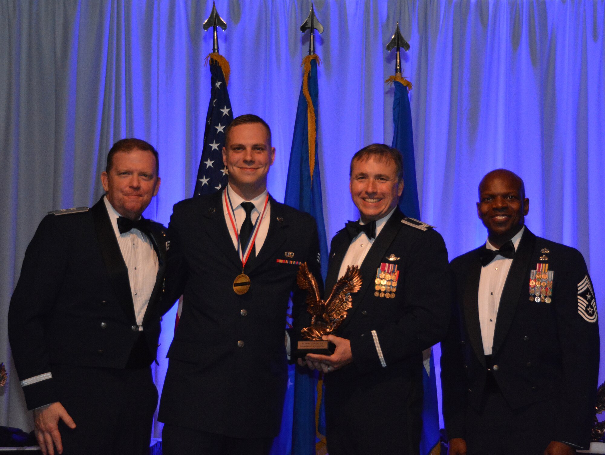 NAVAL AIR STATION FORT WORTH JOINT RESERVE BASE, Texas – Senior Airman Addison Schumacher, 301st Operations Support Flight technician, accepts the 2015 Airman of the Year award from Col. John Breazeale, 301st Fighter Wing commander, Feb. 20 at the Fort Worth Stockyards, Texas. An awards banquet, organized annually, honored nominees and winners in 10 categories for their commitment and devotion to the wing and U.S. Air Force Reserve. (U.S. Air Force photo by Staff Sgt. Samantha Mathison)