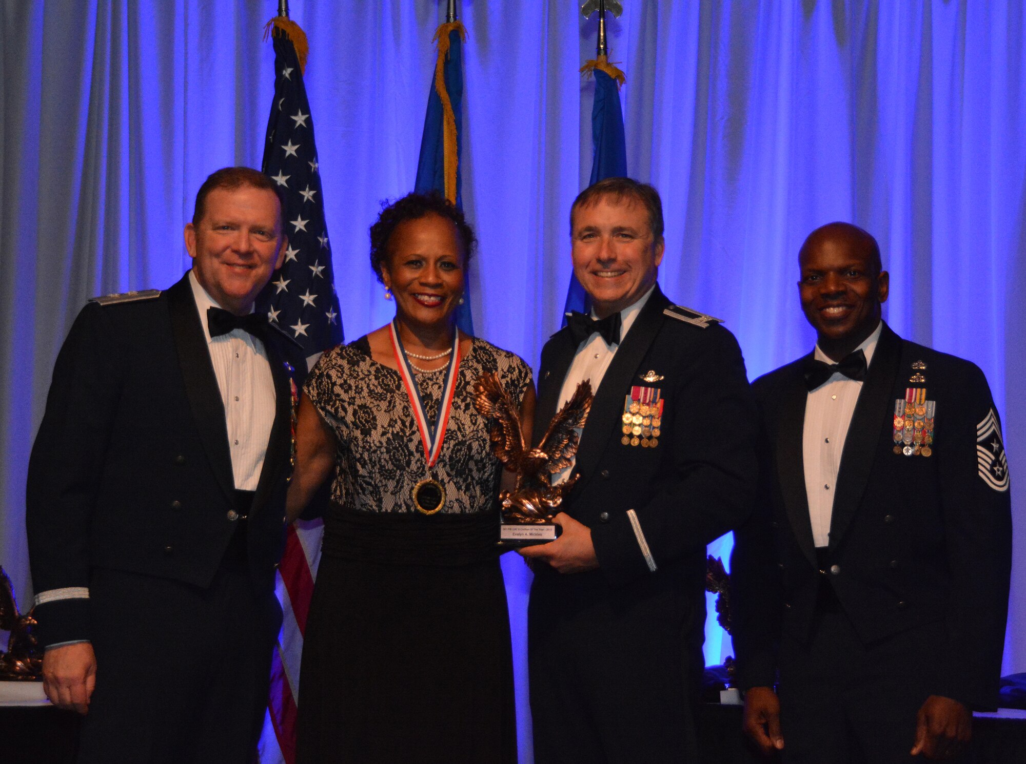 NAVAL AIR STATION FORT WORTH JOINT RESERVE BASE, Texas – Ms. Evelyn Mickles, 301st Fighter Wing legal office, accepts the 2015 Civilian of the Year Category II award from Col. John Breazeale, 301st Fighter Wing commander, Feb. 20 at the Fort Worth Stockyards, Texas. Mickles received the award in recognition of outstanding service to her profession and to the U.S. Air Force Reserve. (U.S. Air Force photo by Staff Sgt. Samantha Mathison)