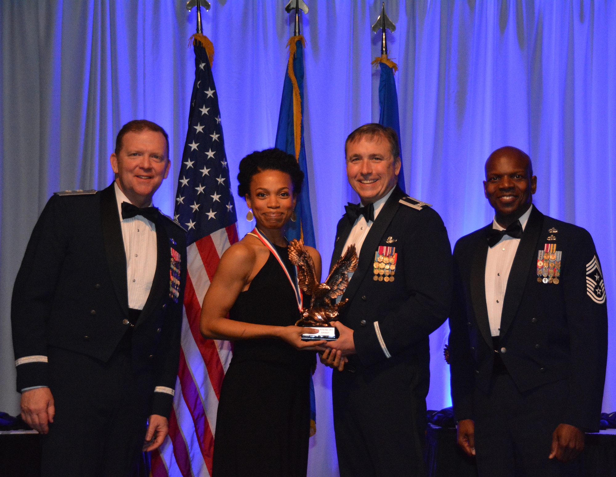 NAVAL AIR STATION FORT WORTH JOINT RESERVE BASE, Texas – Ms. Stephanie Johnson, 44th Fighter Group, Tyndall Air Force Base, Fla., a geographically-separated unit, accepts the 2015 Civilian of the Year Category I award from Col. John Breazeale, 301st Fighter Wing commander, Feb. 20 at the Fort Worth Stockyards, Texas. The award was presented during a formal banquet held annually to recognize the dedication and service of outstanding wing members. (U.S. Air Force photo by Staff Sgt. Samantha Mathison)