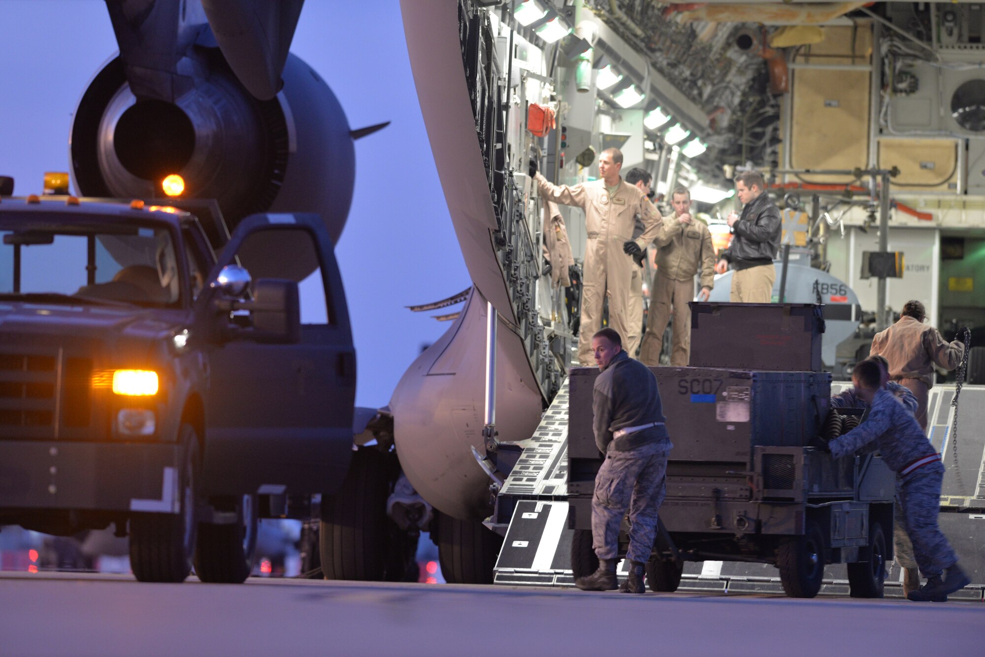 Airmen prepare to connect a power unit to a bobtail vehicle after unloading them from a C-17 Globemaster III at Morón Air Base, Spain, Feb. 24, 2016. This equipment will be used by 2nd Bomb Wing personnel to support bomber operations during Exercise Cold Response 16, a large Norwegian-led NATO exercise involving maritime, land and air components that sustains and strengthens the operational and coordination capabilities of partner nations. (U.S. Air Force photo/Senior Airman Joseph Raatz) 