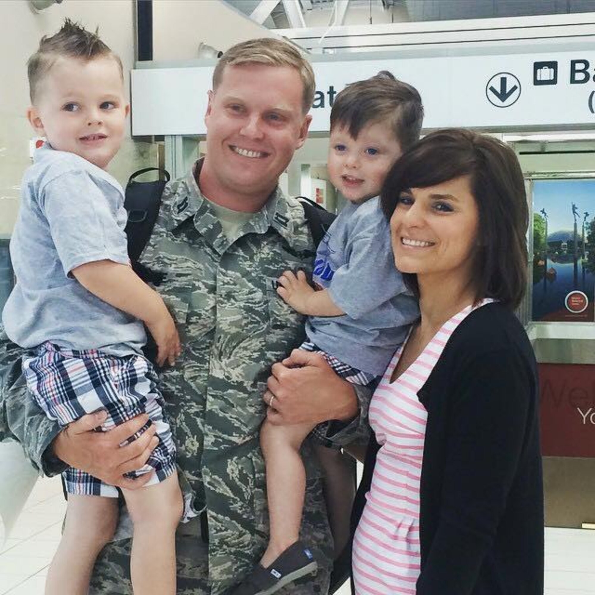 Capt. Bradley Stone poses with his family for a picture. Stone and Senior Airman Samantha Strom, both assigned to the 932nd Aeromedical Evacuation Squadron (Reserve), were touring Pearl Harbor, Hawaii, during down time on a deployment Feb. 18 when they aided in the rescue of helicopter crash victims. (Courtesy photo)