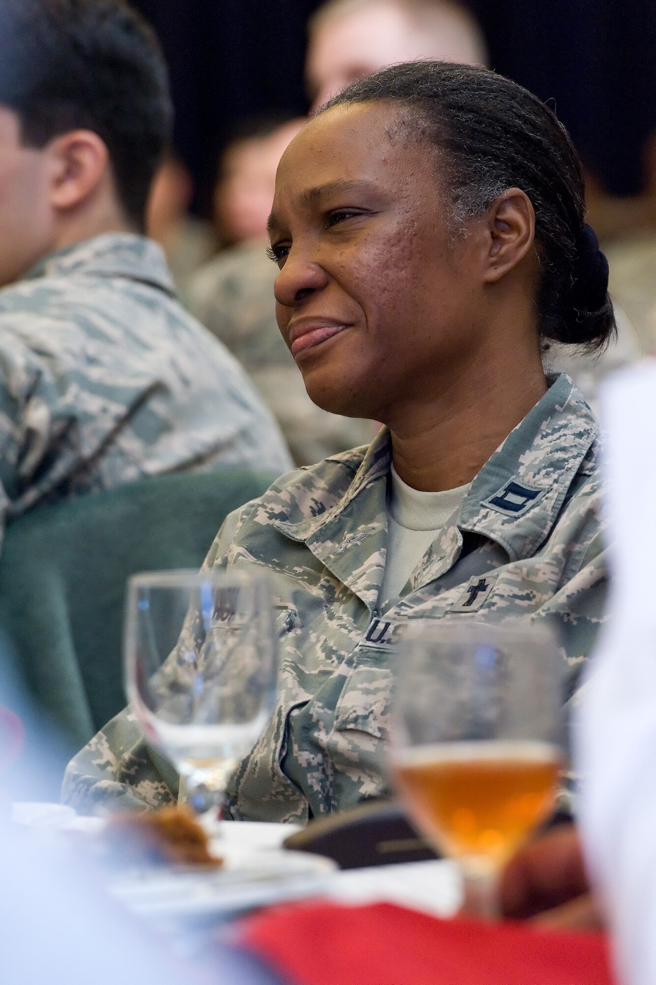 Captain Raecita High, 436th Airlift Wing chaplain, listens to retired Chaplain (Maj. Gen.) Cecil Richardson, former Chief of Air Force Chaplains, Headquarters U.S. Air Force, Washington, D.C., during the National Prayer Luncheon Feb. 18, 2016, at the Landings on Dover Air Force Base, Del. Team Dover members, civic leaders and congressional delegates totaling over 270 people, attended the luncheon to hear Richardson speak, share a meal and enjoy fellowship at this annual event. (U.S. Air Force photo/Roland Balik)