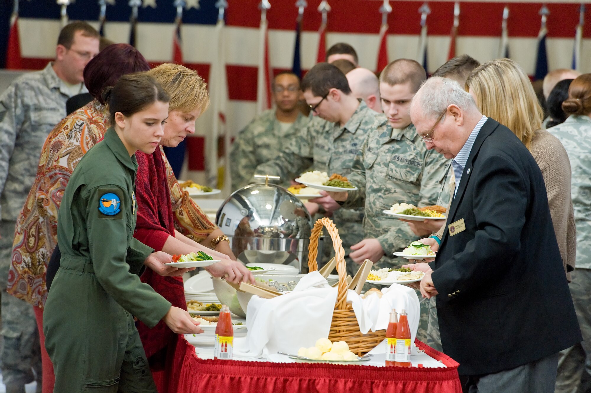 Team Dover members, civic leaders and congressional delegates go through the buffet line during the National Prayer Luncheon Feb. 18, 2016, at the Landings on Dover Air Force Base, Del. Retired Chaplain (Maj. Gen.) Cecil Richardson, former Chief of Air Force Chaplains, Headquarters U.S. Air Force, Washington, D.C., was the keynote speaker for the second year in a row, bringing his messages to those in attendance. (U.S. Air Force photo/Roland Balik)