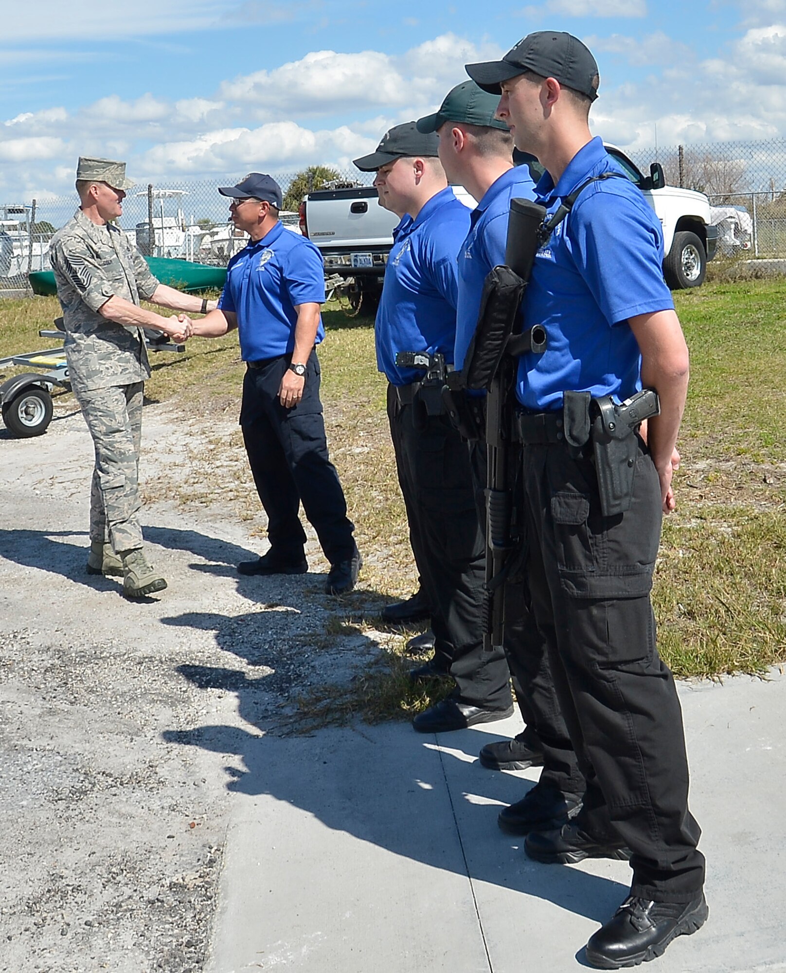 Chief Master Sgt. of the Air Force James A. Cody greets Officer Jesse Gabbert, the officer in charge of marine patrol with the 6th Security Forces Squadron, during his visit to MacDill Air Force Base, Fla., Feb. 22, 2016. Cody rode the waters with marine patrolmen while they demonstrated tactical maneuvers and gave him an insight on their career. (U.S. Air Force photo by Senior Airman Jenay Randolph)