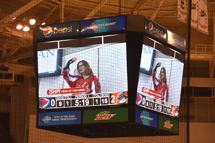 Naval Health Clinic Charleston executive officer Capt. Rosemary Malone is
recognized on the big screen as the Hero of the Game during the South Carolina Stingrays vs.the Greenville Swamp Rabbits hockey game Feb. 18 at the Coliseum in North
Charleston. (Navy photo by Petty Officer 3rd Class Mark Simon)

