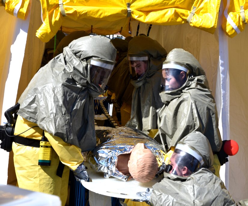 Staff members of Naval Health Clinic Charleston transport a simulated,
contaminated patient through a decontamination tent during a timed Chemical,
Biological, Radiological, Nuclear and Explosives exercise Feb. 18. NHCC's
medical first responders practiced life-saving skills required to triage,
initiate field treatment, decontaminate and save victims during a CBRNE
event. From left to right: hospitalmen Petty Officer 1st Class Terro Walker,
Petty Officer 3rd Class Michael Boeji, Seaman Apprentice Brandy Sandoval;
and Megan Moore, NHCC industrial hygienist. (Navy photo by Petty Officer 3rd
Class Robert Jackson)
