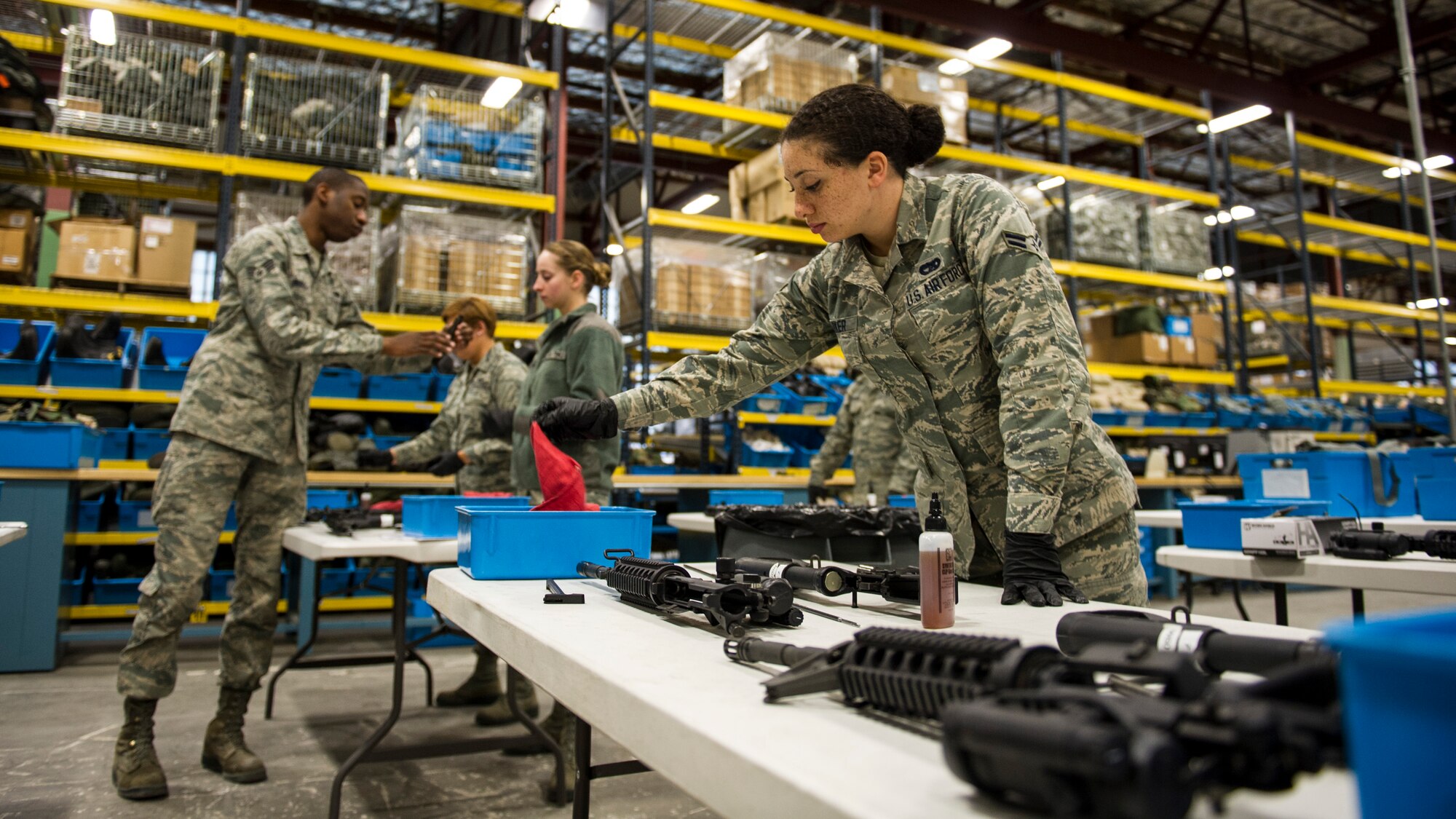 Airman 1st Class Megan Parker, 92nd Logistics Readiness Squadron traffic management apprentice, cleans an M4 carbine during a gas mask and weapons class Feb. 18, 2016, at Fairchild Air Force Base, Wash. The weapons portion starts by teaching everyone how to clear. (U.S. Air Force photo/Airman 1st Class Sean Campbell)