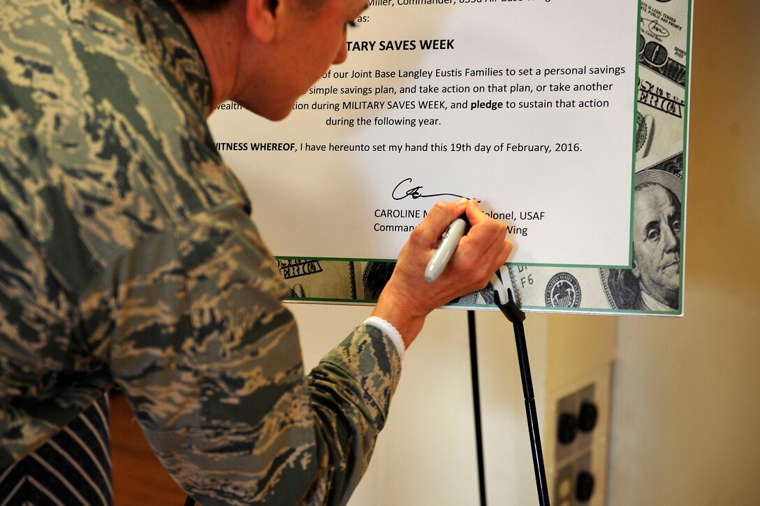 U.S. Air Force Col. Caroline M. Miller, commander of the 633rd Air Base Wing, signs a proclamation at Fort Eustis, Va., Feb. 19, 2016. The proclamation declared that Feb. 22 through 26 was named Military Saves Week. (U.S. Air Force photo by Airman 1st Class Breonna Veal)