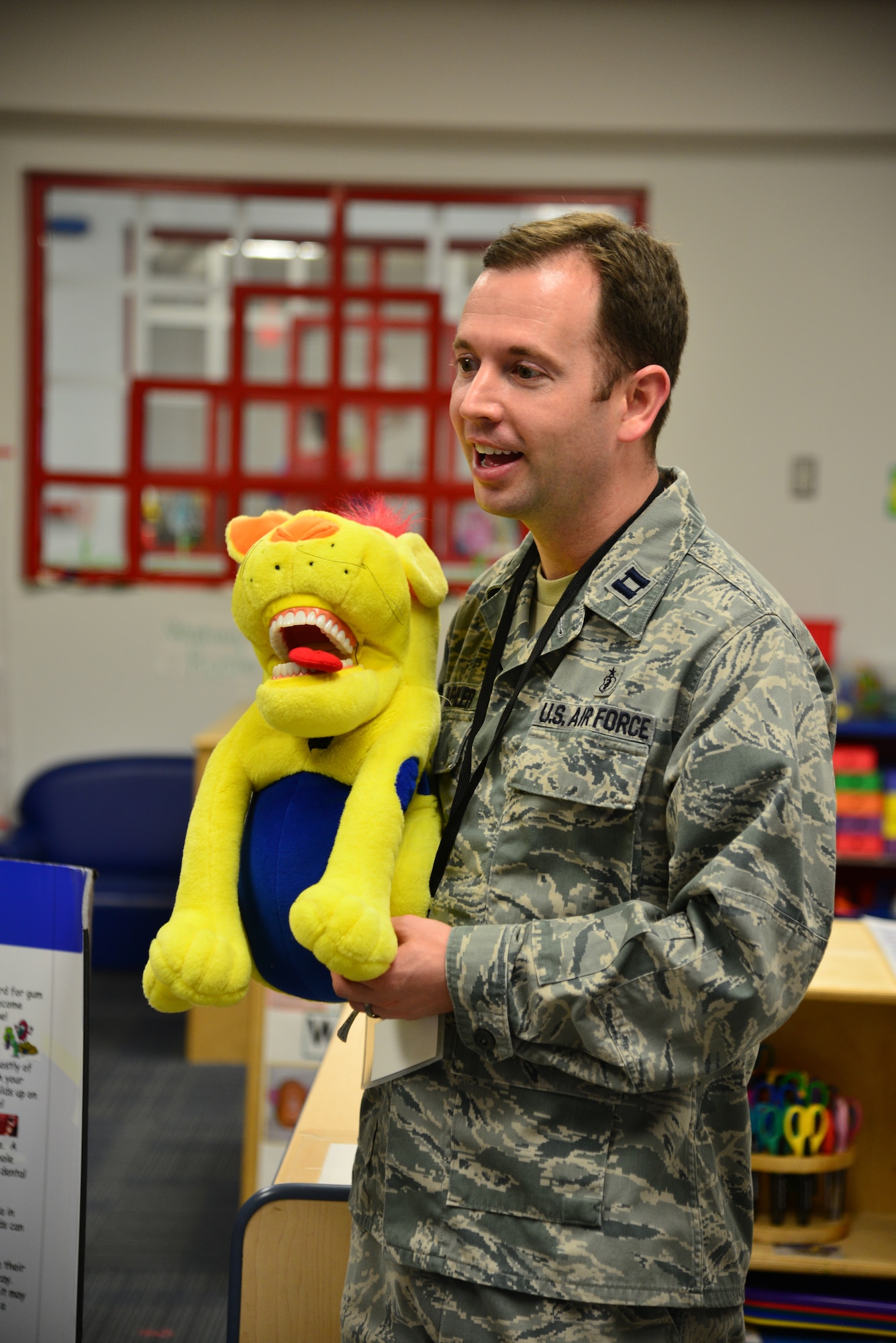 U.S. Air Force Dr. (Capt.) Trent Buehler, dentist assigned to the 633rd Dental Squadron, speaks to children about keeping their teeth healthy at Langley Air Force Base, Va., Feb. 23, 2016. The children learned about the proper way to brush their teeth and floss, in addition to learning about the negative effects of improper dental hygiene. (U.S. Air Force photo by Staff Sgt. Aubrey White)