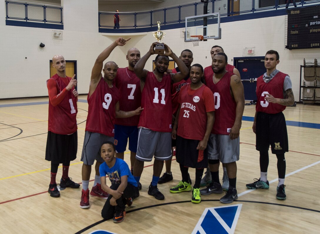 The 633rd Force Support Squadron basketball team poses for a group photo after winning the Intramural Basketball Championship game at Langley Air Force Base, Va., Feb. 23. 2016. The FSS team has won back-to-back intramural basketball championships after defeating the Ryan Center. (U.S. Air Force photo by Senior Airman Kayla Newman)