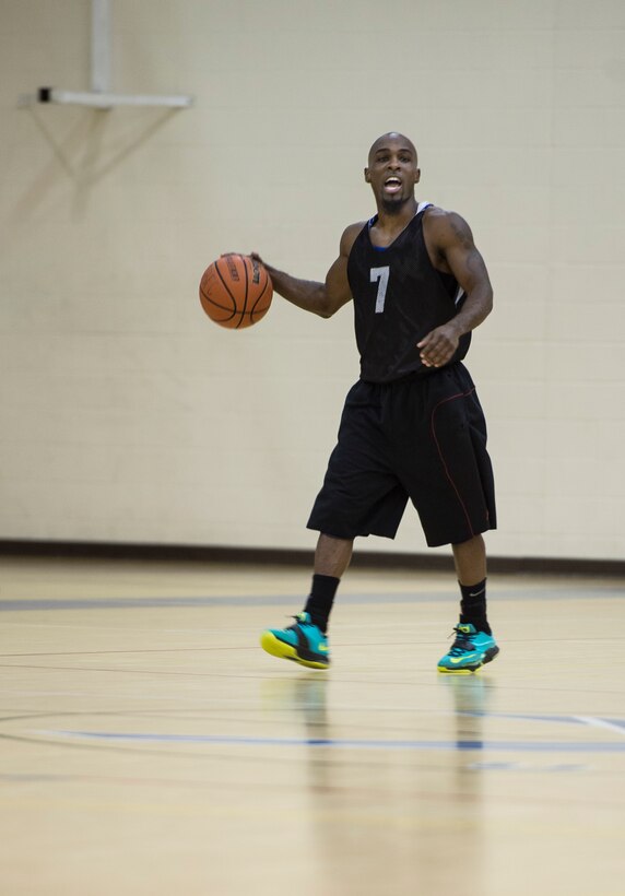 Gregory Smoots, point guard for the Ryan Center basketball team, shouts a play-call during the Intramural Basketball Championship game at Langley Air Force Base, Va., Feb. 23. 2016. The Ryan Center was defeated by the 633rd Force Support Squadron basketball team after two 20-minute periods. (U.S. Air Force photo by Senior Airman Kayla Newman)
