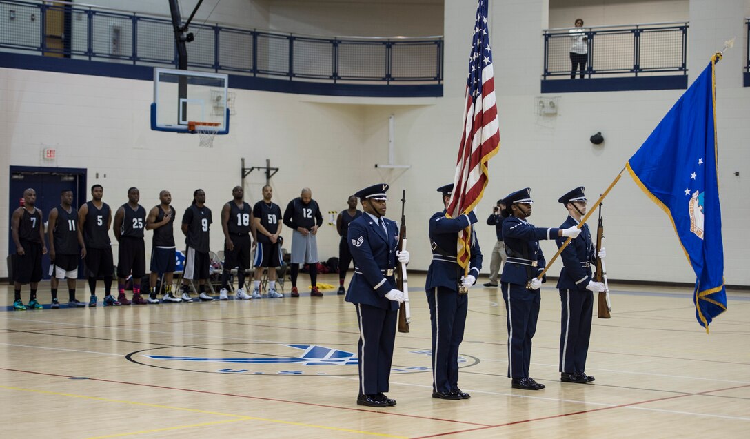 Members of the base Honor Guard present the colors prior to the Intramural Basketball Championship game at Langley Air Force Base, Va., Feb. 23. 2016. The championship game was played between members of the 633rd Force Support Squadron and the Ryan Center. (U.S. Air Force photo by Senior Airman Kayla Newman)