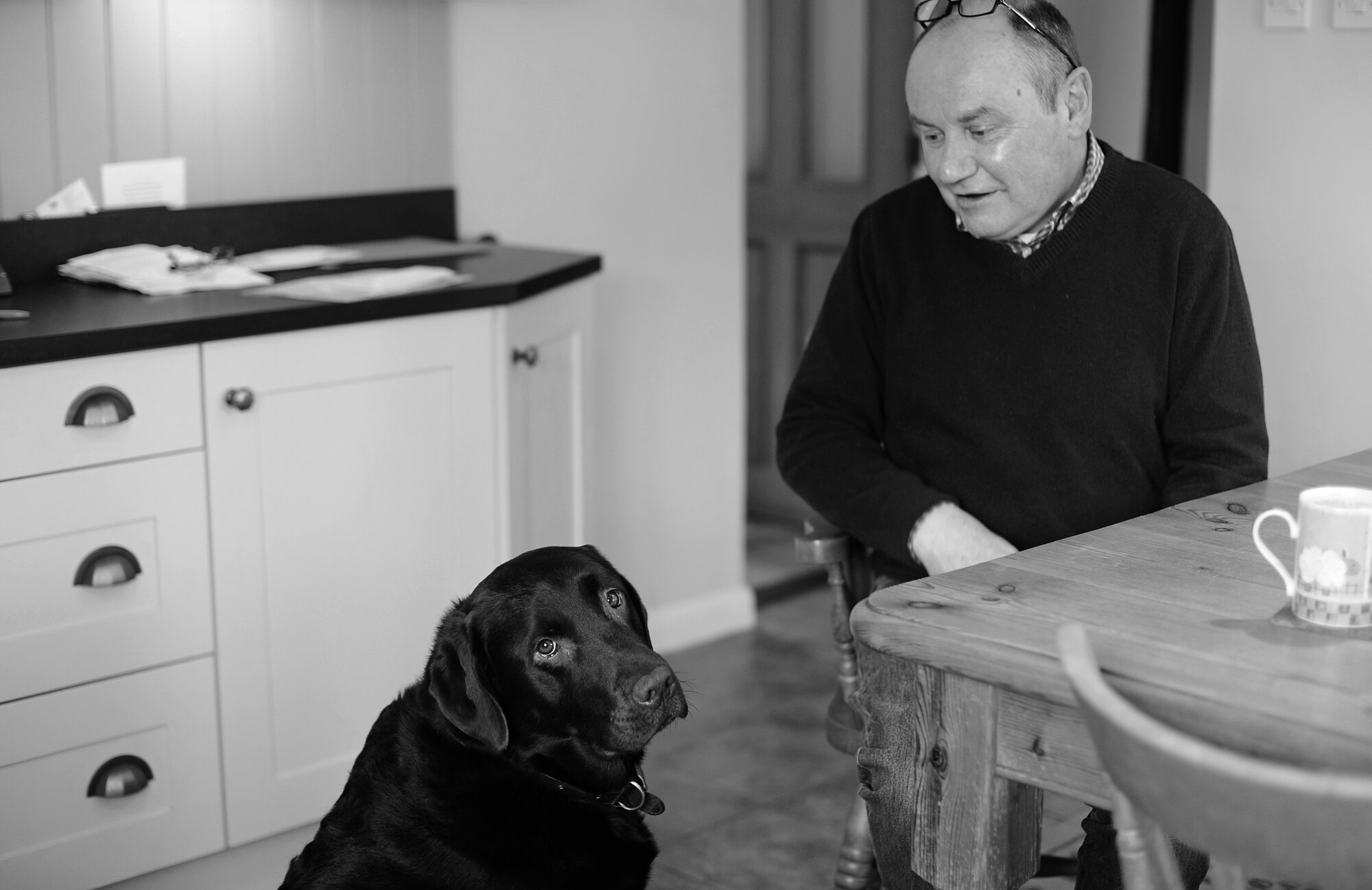 Andrew Aves and his Labrador Retriever, Roland, spend a morning together in the Aves home near Hinderclay, England. Since 1996, Mr. Aves has invited military bases from across Europe, including U.S. personnel assigned to Royal Air Force bases, to use his property for training exercises. (U.S. Air Force photo/Senior Airman Erin Trower) 