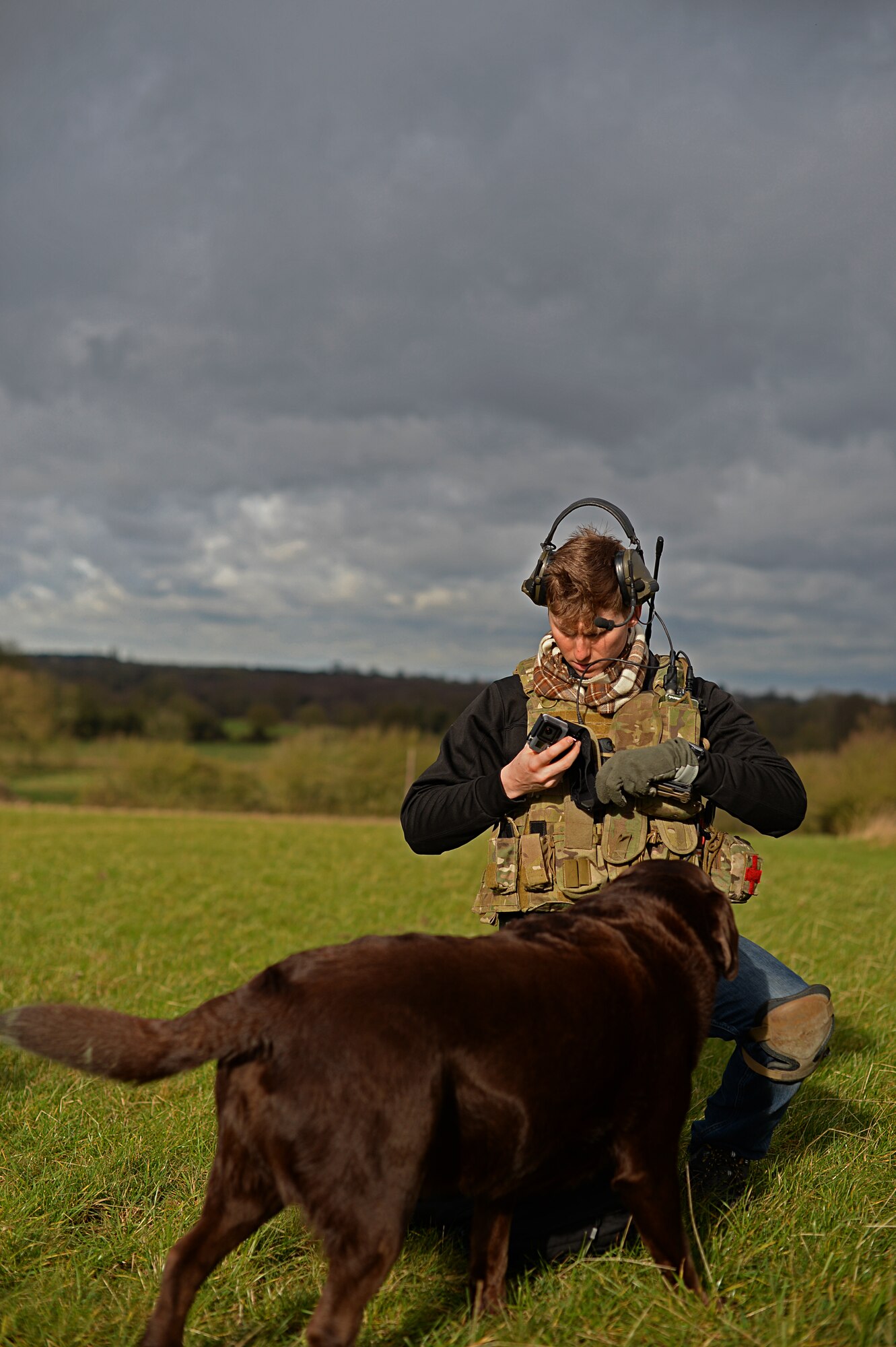 Roland, a Labrador Retriever belonging to Andrew Aves, and Staff Sgt. Joseph Bland, 56th Rescue Squadron special missions aviator, prepare to participate in a combat search and rescue task force training exercise near Hinderclay, England, Feb. 4, 2016. The training focused on rescue techniques and involved various squadrons and personnel assigned to the 48th Fighter Wing and 100th Air Refueling Wing. (U.S Air Force photo/Senior Airman Erin Trower) 