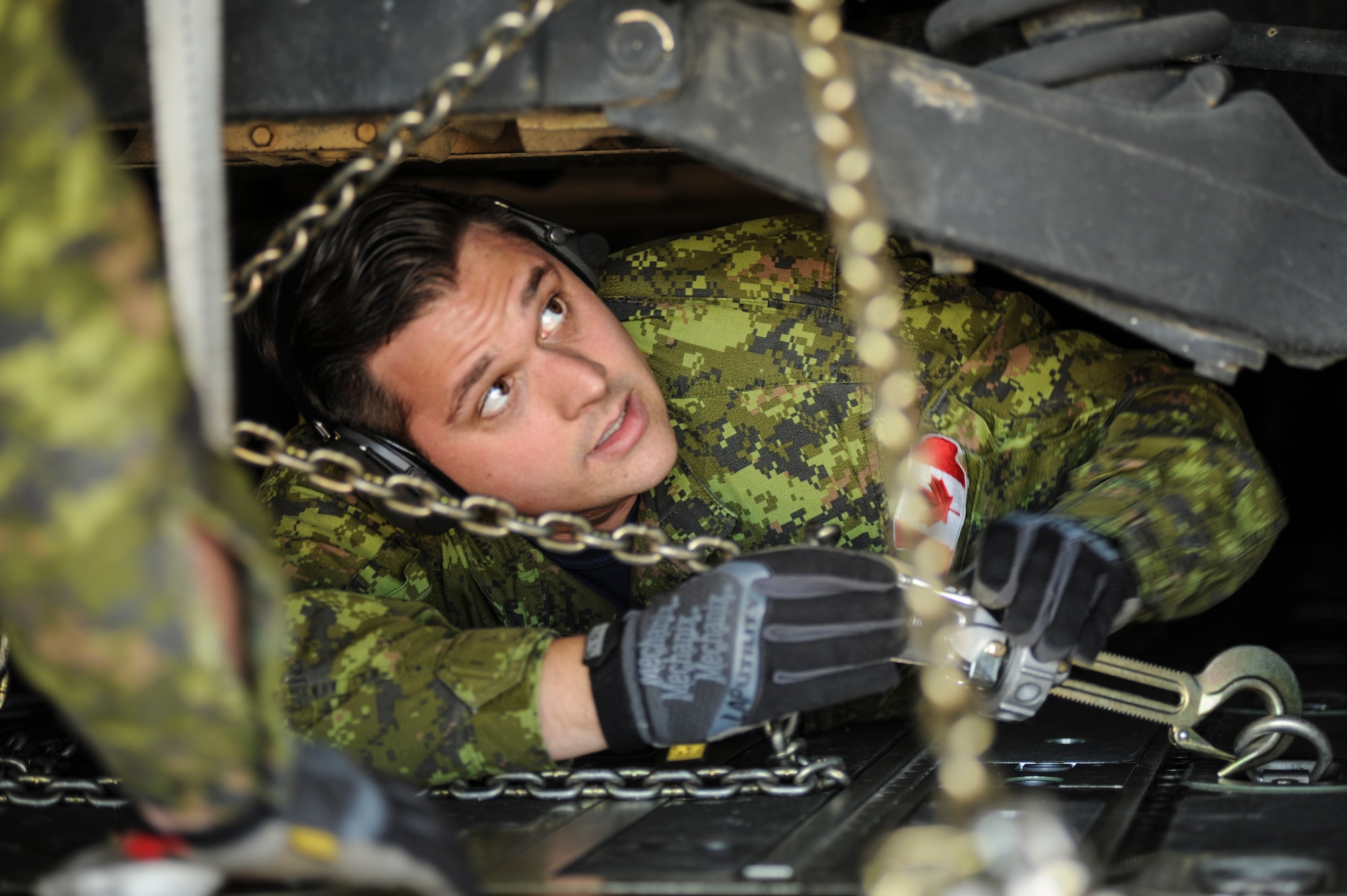 A Royal Canadian Air Force C-130J loadmaster straps a U.S. Army Humvee to the back of a U.S. Air Force C-130J, Feb. 17, 2016, near Fort Polk, La. The RCAF aircrew spent two week at Little Rock Air Force Base, Ark. to practice and improve on combat airlift operations with U.S. coalition forces during GREEN FLAG 16-04. (U.S. Air Force photo/Senior Airman Harry Brexel)