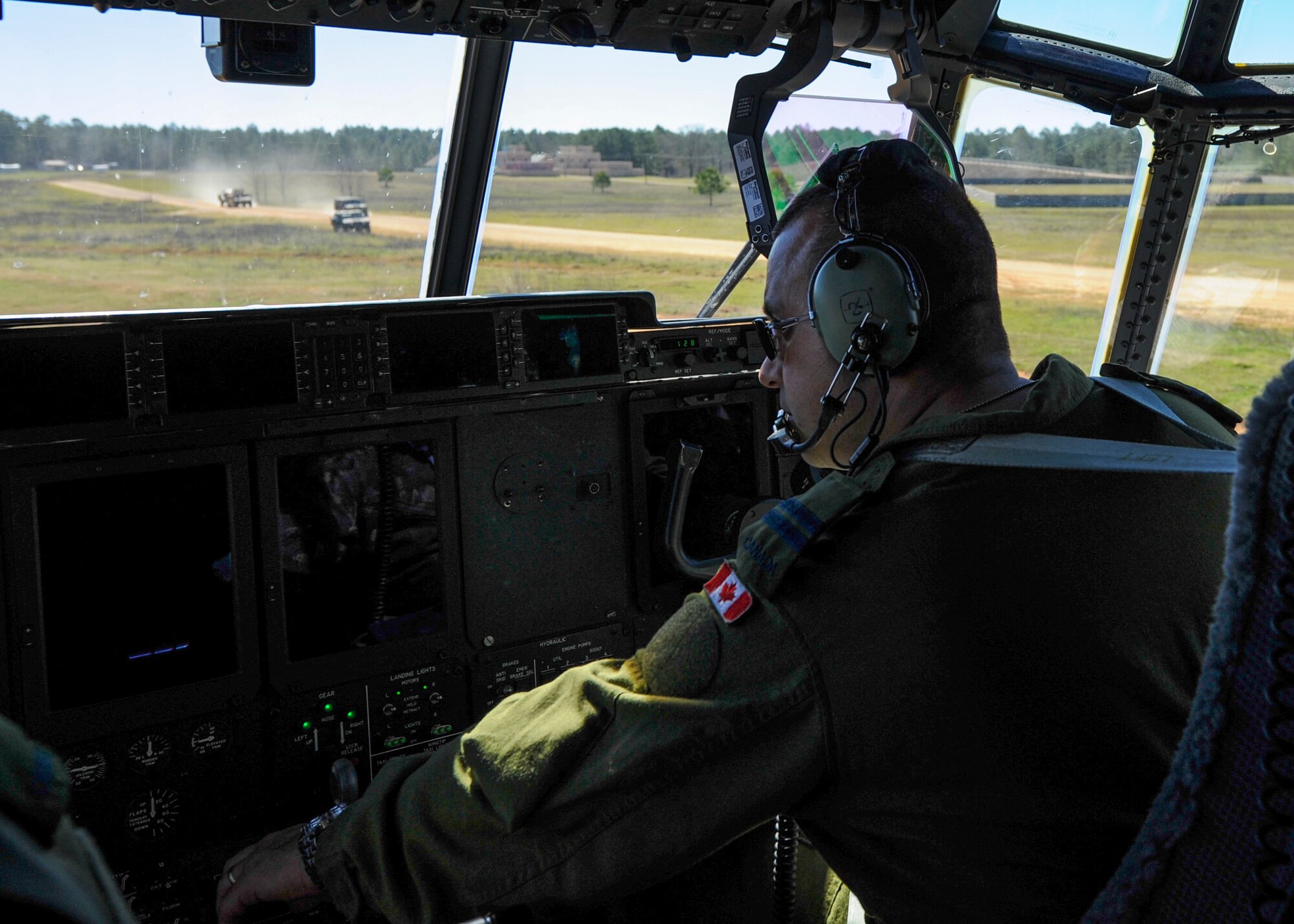 A Royal Canadian Air Force C-130J pilot taxis to a parking spot shortly after landing, Feb. 17, 2016, at the Geronimo Landing Zone on Fort Polk, La. The RCAF aircrew spent two week at Little Rock Air Force Base, Ark., to train with U.S. coalition forces during GREEN FLAG 16-04. (U.S. Air Force photo/Senior Airman Harry Brexel)
