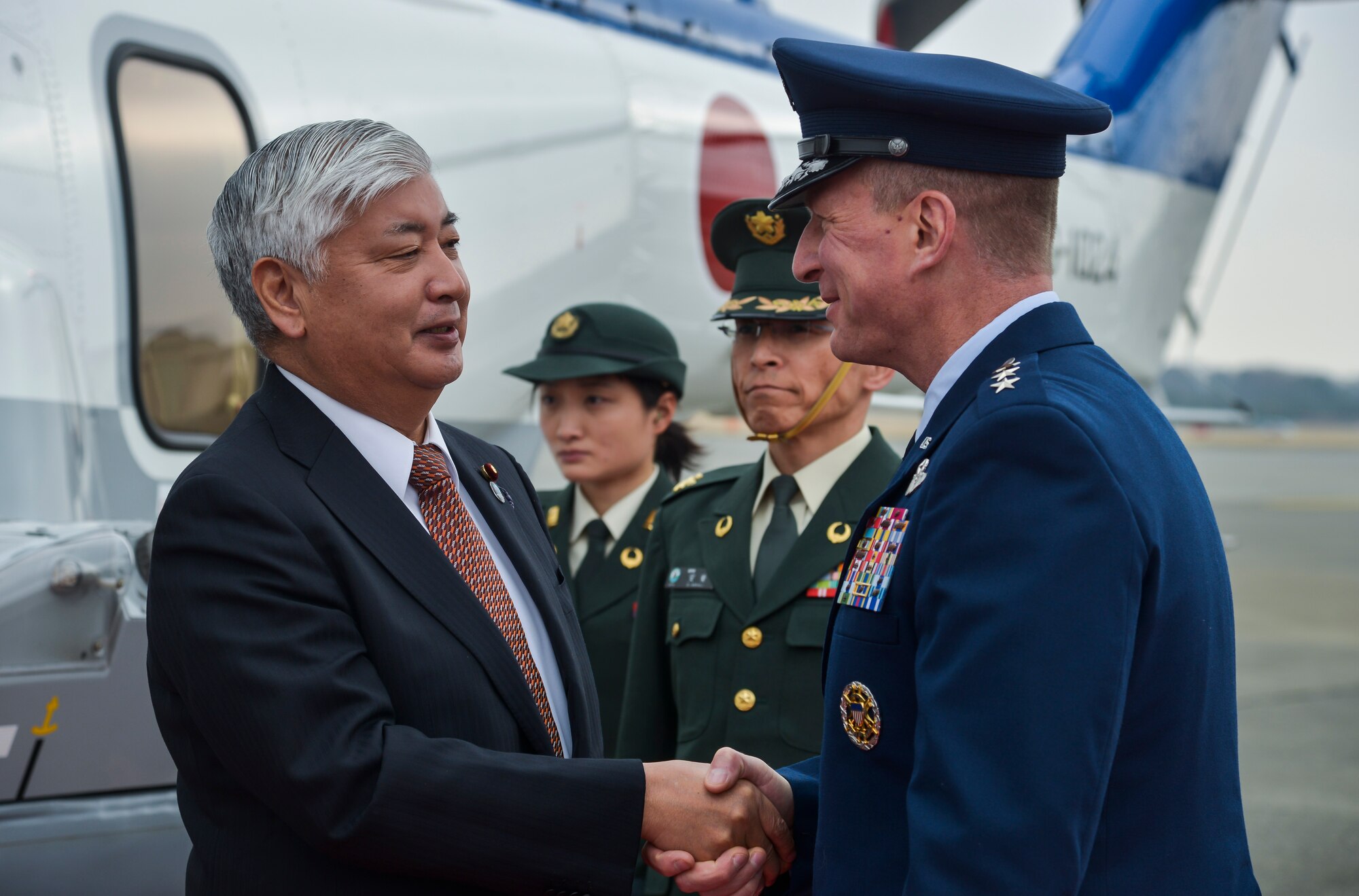 Lt. Gen. John Dolan, U.S. Forces, Japan and 5th Air Force commander, greets Gen Nakatani, Minister of Defense for Japan, as he steps off of the helicopter at Yokota Air Base, Japan, Feb. 23, 2016. During his visit, Nakatani received a USFJ orientation, toured the Air Defense Command building and met with US military and Japanese leaders. (U.S. Air Force photo by Senior Airman David Owsianka/Released)