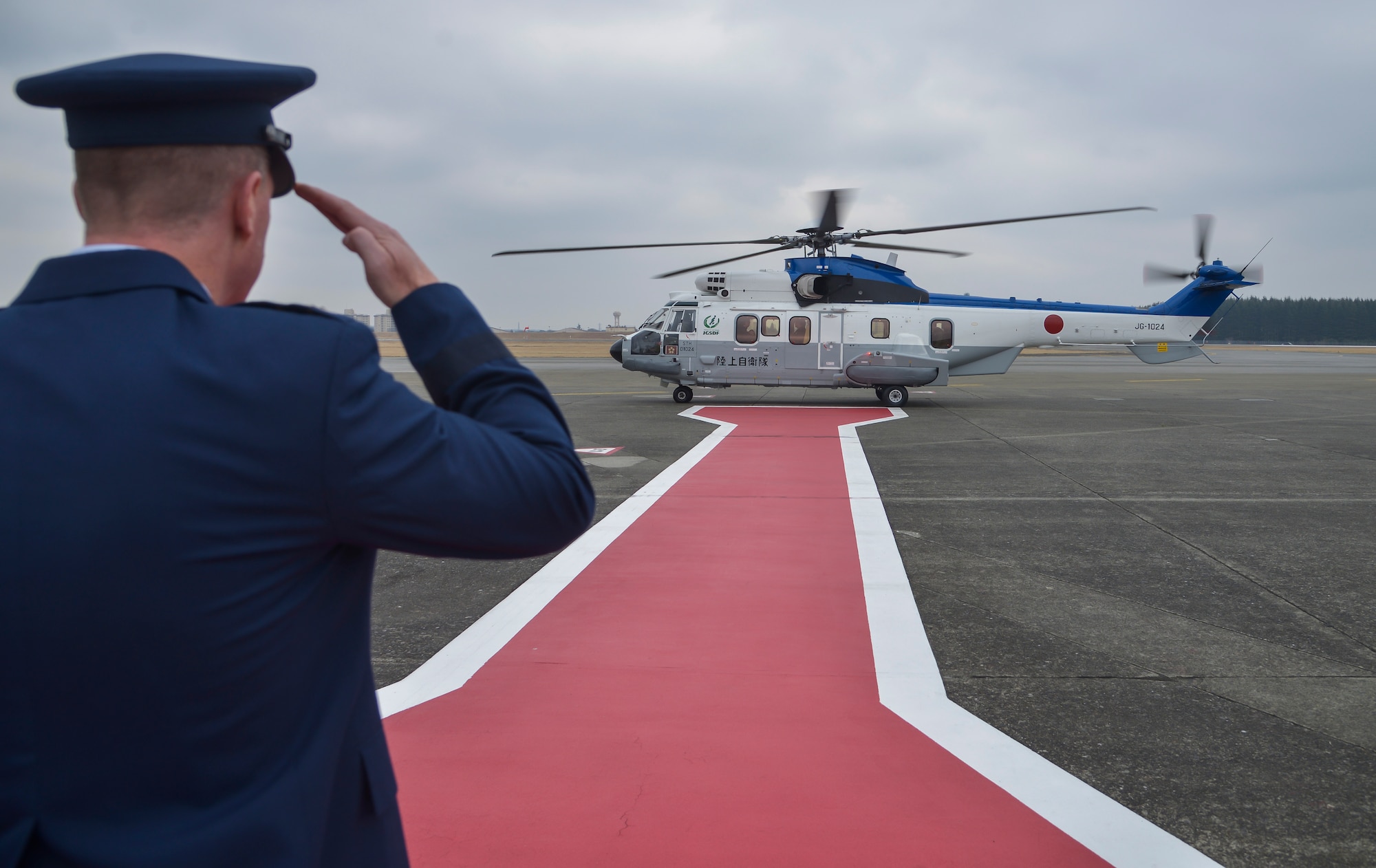 Lt. Gen. John Dolan, U.S. Forces, Japan and 5th Air Force commander, salutes a helicopter with Gen Nakatani, Minister of Defense for Japan, at Yokota Air Base, Japan, Feb. 23, 2016. Nakatani received briefings about the U.S. Forces, Japan mission and defense of Japan during his visit to the base. (U.S. Air Force photo by Senior Airman David Owsianka/Released)