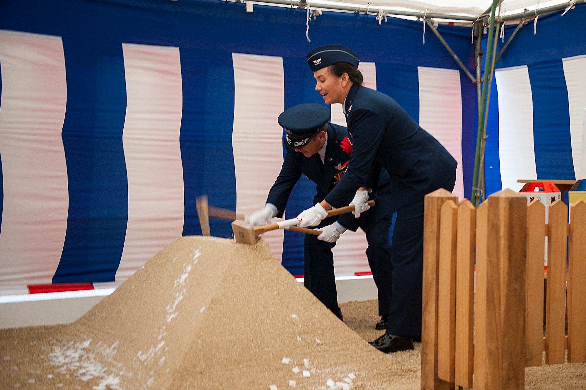 U.S. Air Force Col. Christopher Amrhein, 18th Wing vice commander, and Col. Debra Lovette, 18th Mission Support Group commander, dig into a pile of dirt during a ground breaking ceremony Feb. 24, 2016, at Kadena Air Base, Japan. The ceremony was held to begin construction on the new $47 million Rocker NCO club, which was closed for reconstruction at the beginning of 2016. A Shinto priest performed a traditional purification ritual to ask the spirits for safety during the construction. (U.S. Air Force photo by Airman 1st Class Corey M. Pettis)  