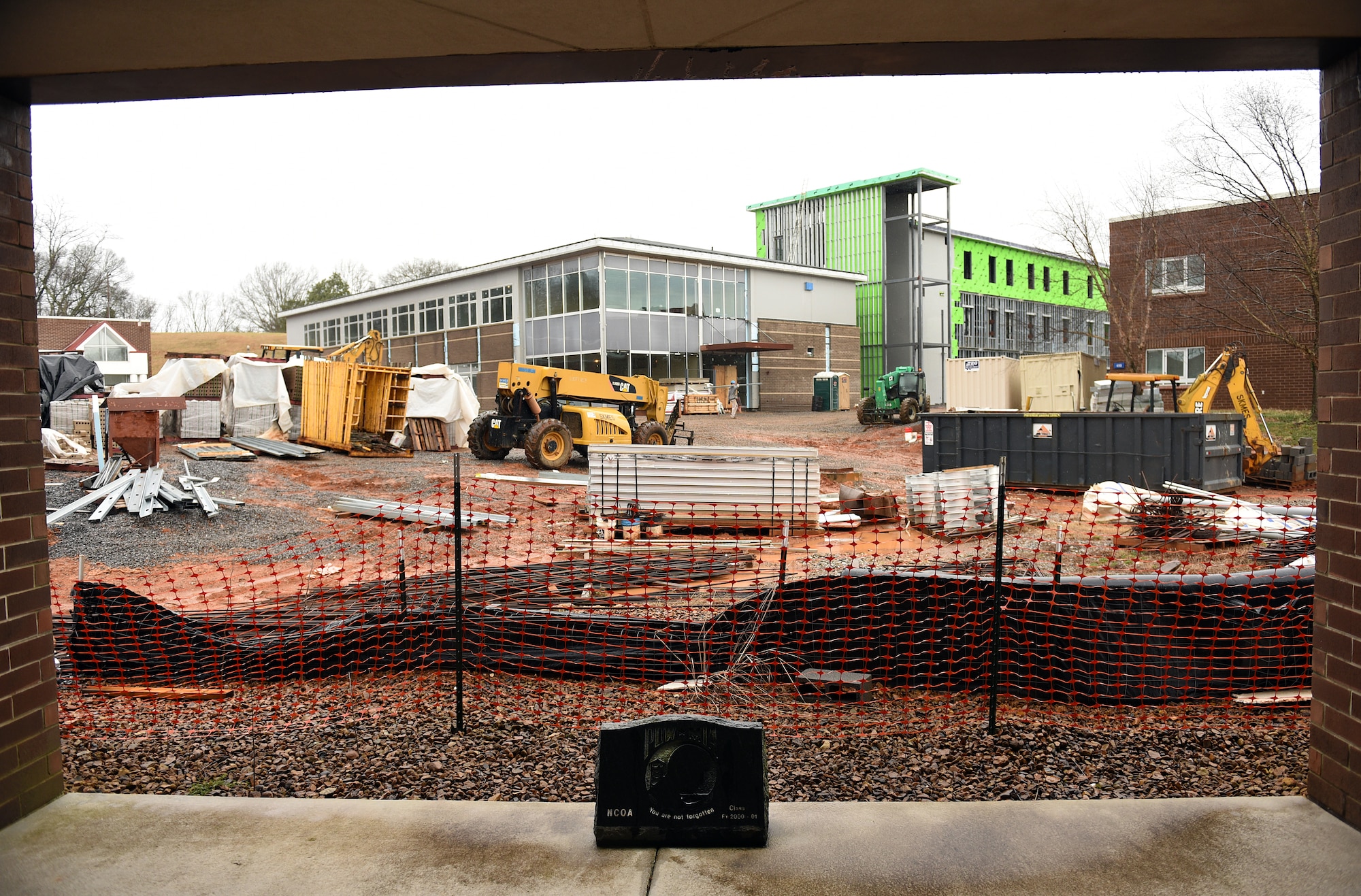 MCGHEE TYSON AIR NATIONAL GUARD BASE, Tenn. - A worn, POW MIA memorial stone sits just inside the north entrance to the Morrisey Hall classroom building on a rainy Wednesday at the I.G. Brown Training and Education Center here Feb. 24, 2016, with the facility construction in the distance. This entrance to the inner campus is blocked until completion. The stone was donated by NCO academy class FY 2000-1. (U.S. Air National Guard photo by Master Sgt. Mike R. Smith/Released)