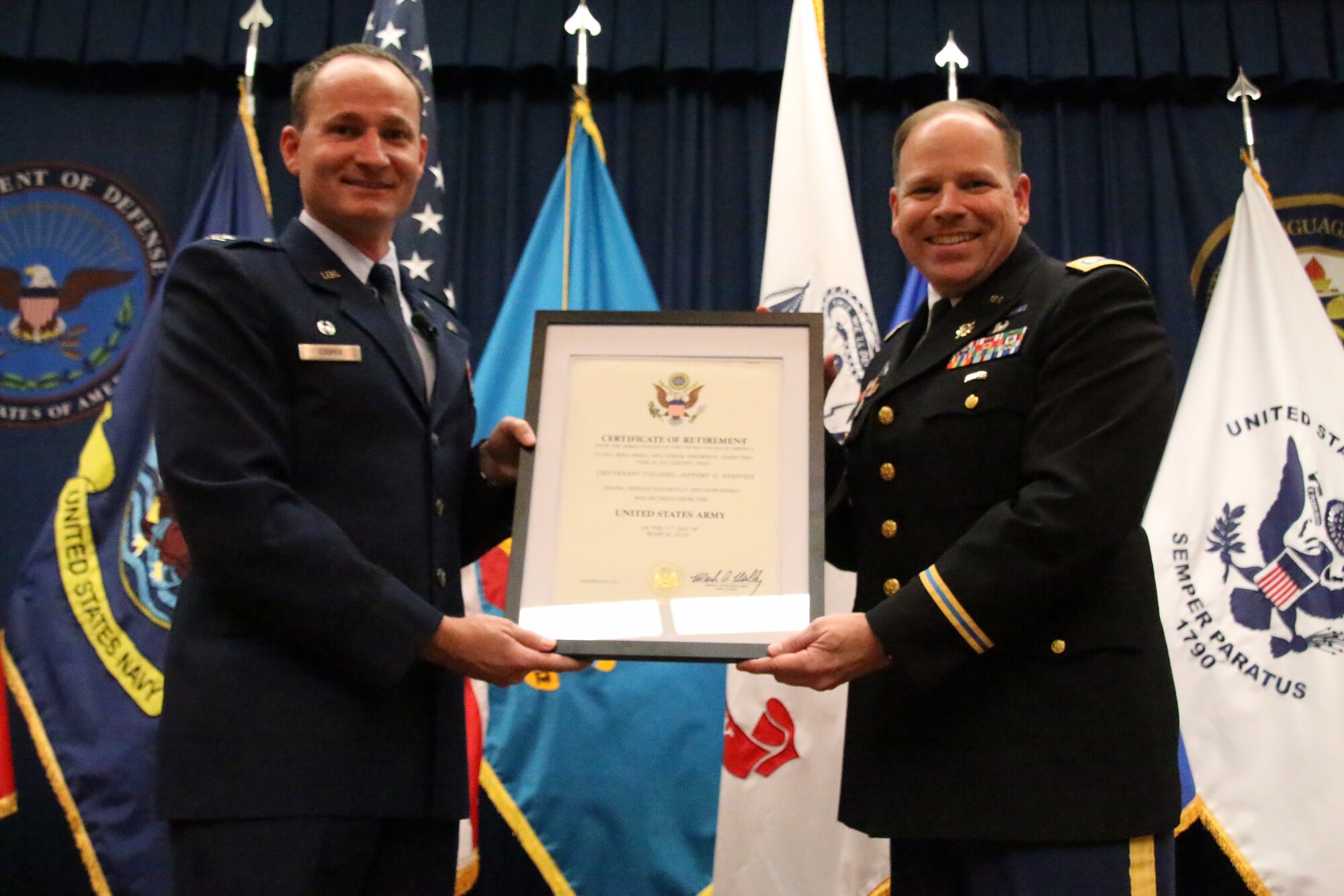 Lt. Col. Jeffery Stephen, former deputy commander of the Defense Language Institute English Language Center at Joint Base San Antonio-Lackland, receives a certificate of appreciation from Col. Jeffery Cooper, DLIELC commandant and 673th Training Group commander during Steffen's retirement ceremony Jan. 30, 2016. Steffen returned to DLIELC soon after his military retirement to become an English instructor.