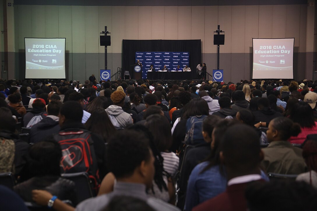 Students participating in the Central Intercollegiate Athletic Association (CIAA) High School Education Day grab their seats as Staff Sgt. Eric Rogers, canvassing recruiter from Recruiting Substation Charlotte, begins remarks at the Charlotte Convention Center on Feb. 24, 2016. High school students from around the Charlotte area participated in the event to learn about career and education opportunities. The Marine Corps has participated in CIAA events for more than 15 years and will be present for the 2016 CIAA basketball tournament. (Official Marine Corps Photo by Cpl. John-Paul Imbody)
