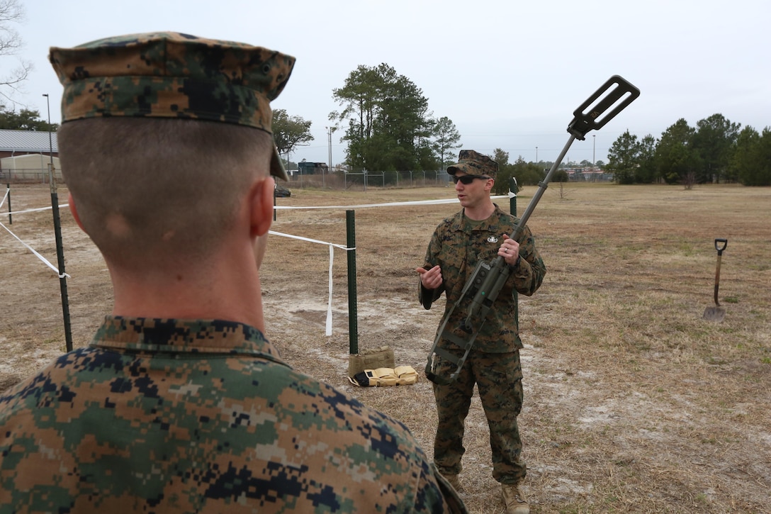 Sgt. Dereck Ford, a technician with Explosive Ordnance Disposal Company, teaches Marines with Combat Logistics Battalion 2 how to power up and recalibrate a metal detector during an improvised explosive device training exercise at Camp Lejeune, N.C., Feb. 23, 2016. CLB-2 Marines learned how to recognize signs of an IED and use the detector to identify the type of IED that may be present as they conducted hands-on training in preparation for their upcoming deployment with Special Purpose Marine Air Ground Task Force Crisis Response Africa. (U.S. Marine Corps photo by Lance Cpl. Aaron K. Fiala/Released)