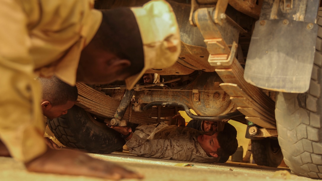 Cpl. Josh Sizelove, a motor transportation mechanic, explains parts of a truck to his Mauritanian counterparts during training in Tiguet, Mauritania, Jan. 27, 2016. Marines and sailors with the Special-Purpose Marine Air-Ground Task Force Crisis Response-Africa trained with the Mauritanian Logistics Battalion for five weeks to assist in building its capacity to counter terrorism and provide sovereign security.