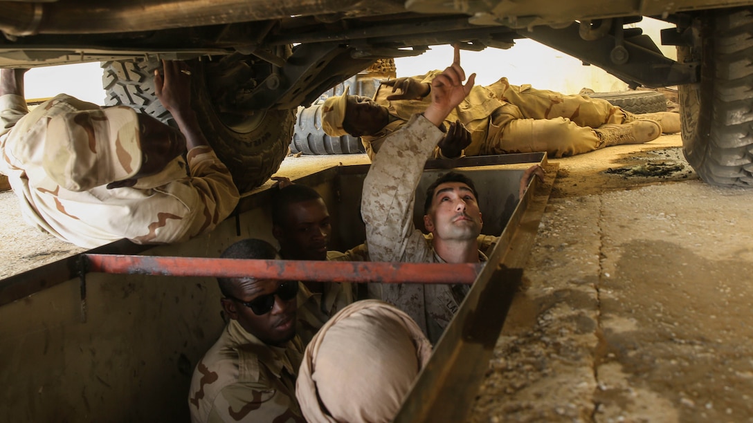 Sgt. Doug Lancie, a motor transportation mechanic, explains parts of a Humvee to Mauritania soldiers during training in Tiguet, Mauritania, Jan. 28, 2016. Marines and sailors with the Special-Purpose Marine Air-Ground Task Force Crisis Response-Africa trained with the Mauritanian Logistics Battalion for five weeks to assist in building its capacity to counter terrorism and provide sovereign security. 