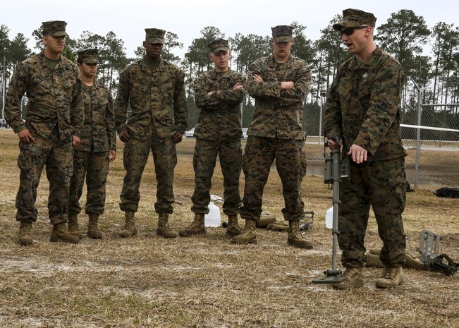 Sgt. Dereck Ford, a technician with Explosive Ordnance Disposal Company, teaches Marines with Combat Logistics Battalion 2 how to power up and recalibrate a metal detector during an improvised explosive device training exercise at Camp Lejeune, N.C., Feb. 23, 2016. CLB-2 Marines learned how to recognize signs of a buried IED and use the detector to identify the type of IED as they conducted hands-on training in preparation for their upcoming deployment with Special Purpose Marine Air Ground Task Force Crisis Response Africa. (U.S. Marine Corps photo by Lance Cpl. Aaron K. Fiala/Released)