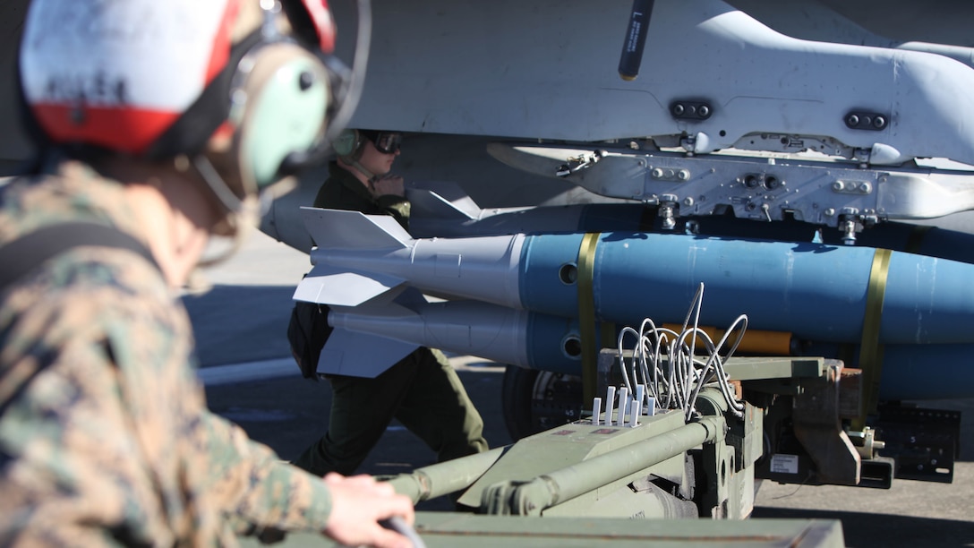 Marines operating an A/S 32K-1A/1B/1C SATS Weapon Loader load BDU-45 practice bombs onto an F/A-18 Hornet during Exercise Coastal Predator at Marine Corps Air Station Cherry Point, N.C., Feb. 16, 2016. The practice bombs fall according to the trajectory of the aircraft while in flight and are used for training purposes. Coastal Predator is an exercise that includes Marine Corps and Army aviation assets along with Air Force personnel and civilian contractors to conduct Forward Air Controller Airborne training in accordance with the pre-deployment training program. 