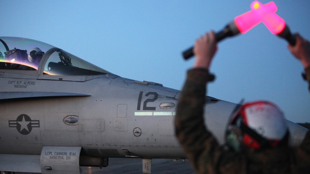 Cpl. Ross McClanahan directs an F/A-18 Hornet pilot during Exercise Coastal Predator at Marine Corps Air Station Cherry Point, N.C., Feb. 16, 2016. Coastal Predator is an exercise that included Marine Corps and Army aviation assets along with Air Force personnel and civilian contractors to conduct Forward Air Controller Airborne training in accordance with the pre-deployment training program. McClanahan is an aircraft ordnance technician with Marine All Weather Fighter Attack Squadron 533. 