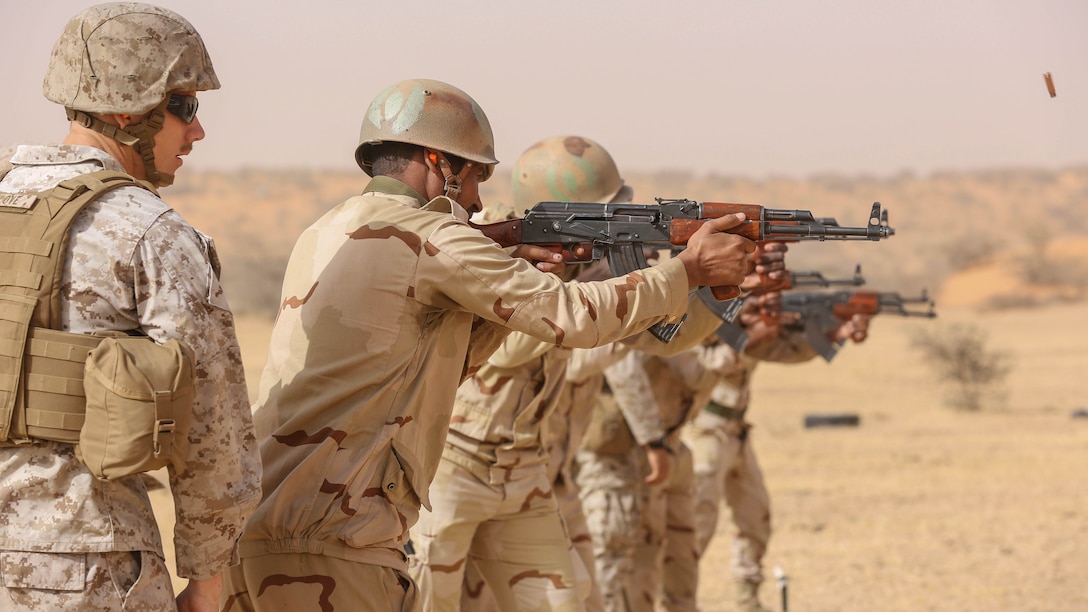 Cpl. Josh Sizelove, a motor transportation mechanic, observes a soldier conducting a marksmanship drill during training in Tiguet, Mauritania, Feb. 16, 2016. Marines and sailors with the Special-Purpose Marine Air-Ground Task Force Crisis Response-Africa trained with the Mauritanian Logistics Battalion for five weeks to assist in building its capacity to counter terrorism and provide sovereign security. 