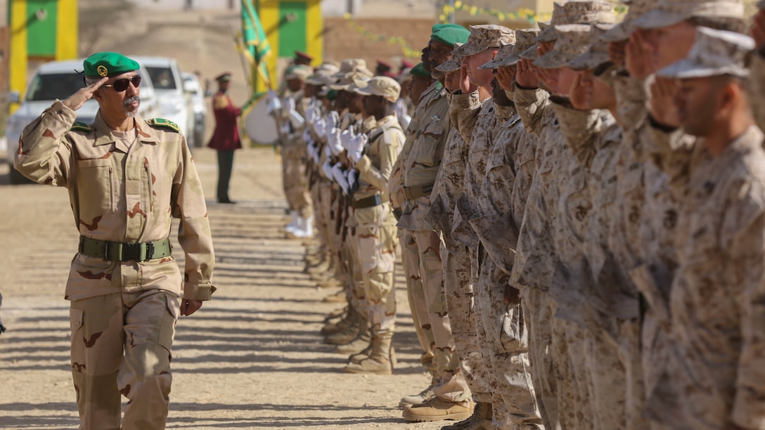 Marines and Sailors salute the Mauritanian Deputy Chief of Defense, Brig. Gen. Hanana Sidi Hanana (left), as he arrives for the graduation ceremony of the soldiers who participated in the logistics training in Tiguet, Islamic Republic of Mauritania, Feb. 19, 2016. Marines with Special-Purpose Marine Air-Ground Task Force Crisis Response-Africa spent five weeks with their Mauritanian counterparts training specialties including motor transportation and operations, supply, communications, medical and marksmanship.  The training between the two militaries builds the Mauritanians’ logistics capacity to provide sovereign security and counter terrorism while strengthening the bond between the two countries. 