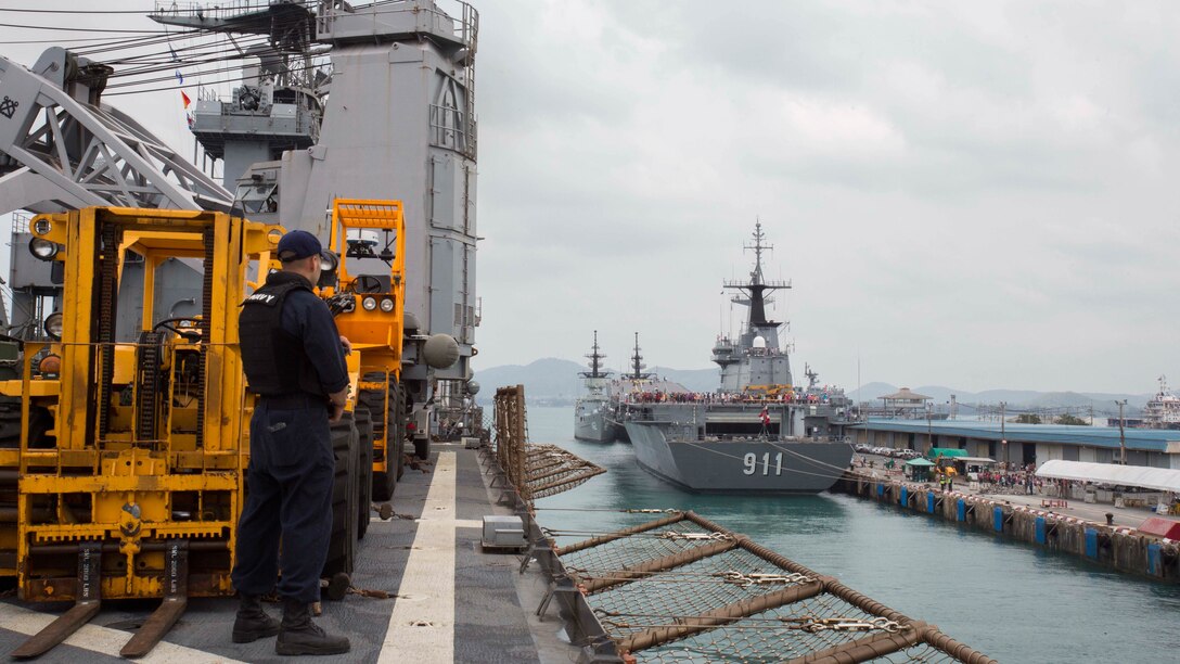 U.S. Navy sailor Gunners Mate 3rd Class Frank Rivas watches as the USS Ashland departs from the Port of Sattahip, Thailand, Feb. 21, 2016. Leaving port ended the 31st Marine Expeditionary Unit's stay for Cobra Gold 16, an annual exercise that increases cooperation, interoperability and collaboration among partner nations in order to achieve effective solutions to common challenges. 