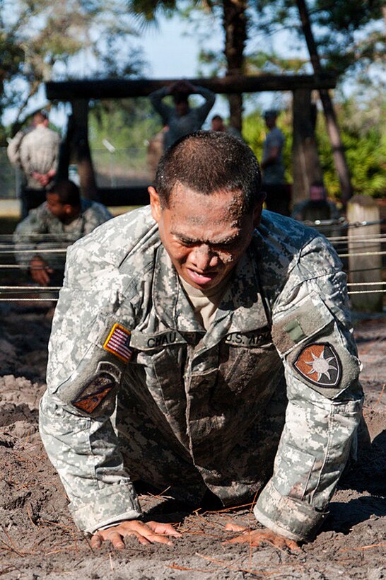 Army Sgt. Chau crawls through a trench during the obstacle portion of the Army Air Assault Course held at Camp Blanding Joint Training Center, Starke, Fla., Feb. 23, 2016. Chau is assigned to the Florida National Guard. Florida Army National Guard photo by Sgt. Christopher Milbrodt