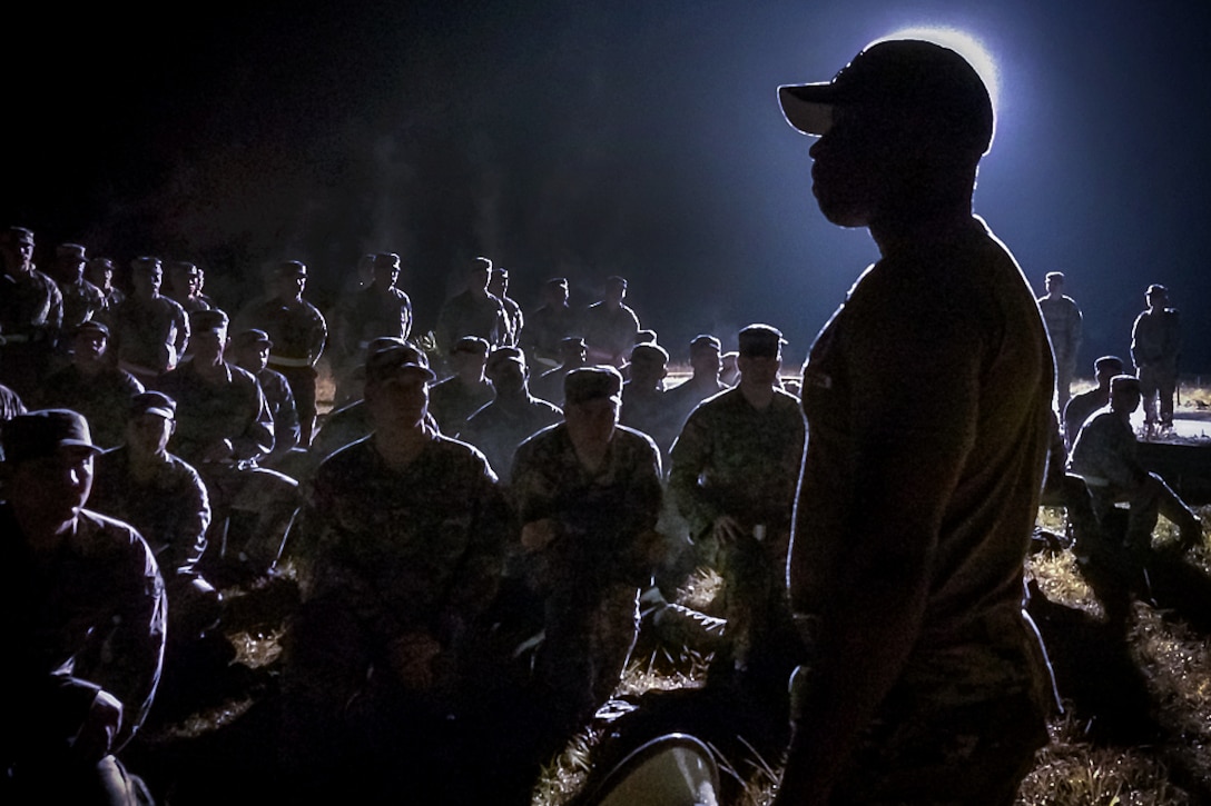 An Army instructor briefs soldiers and airmen before they participate in an Army air assault course on the Camp Blanding Joint Training Center in Starke, Fla., Feb. 23, 2016. The troops must pass an obstacle course, ruck marches, multiple runs and slingload operations to graduate from Air Assault School. Florida Army National Guard photo by Ching Oettel