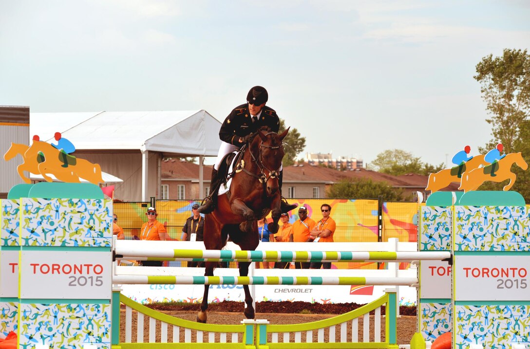 Spc. Nathan Schrimsher of the U.S. Army World Class Athlete Program rides a horse named Taboo en route to earning a berth in the 2016 Olympic Games with a third-place finish in men's Modern Pentathlon at the 2015 Pan American Games on July 19 in Toronto. U.S. Army photo by Tim Hipps, IMCOM Public Affairs #WCAP #RoadToRio #TeamUSA #2015PanAmerican Games