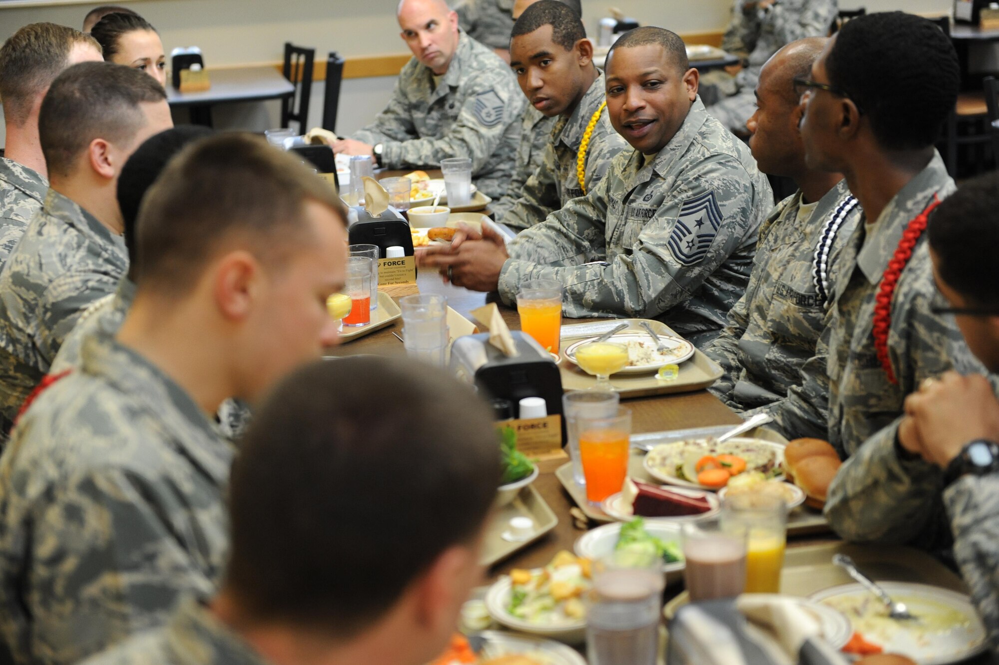 Chief Master Sgt. Farrell Thomas, 2nd Air Force command chief, has lunch with technical training students at the Azalea Dining Facility during an immersion tour Feb. 22, 2016, Keesler Air Force Base, Miss. Thomas visited the 81st Training Wing to become oriented with group missions, operations and personnel.  (U.S. Air Force photo by Kemberly Groue)