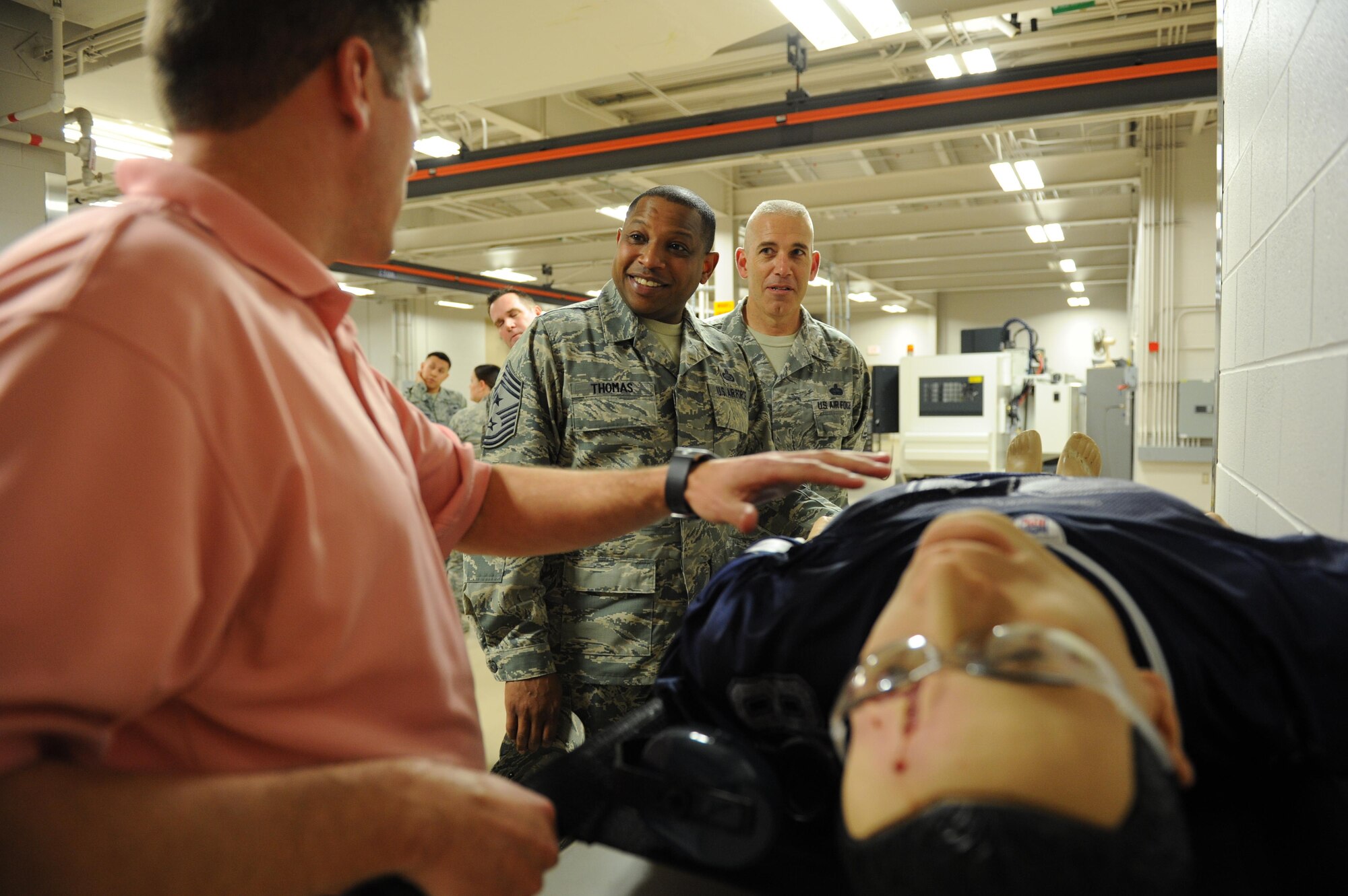 Tomme Lassabe, 81st Training Support Squadron training technology flight chief, shows Chief Master Sgts. Farrell Thomas, 2nd Air Force command chief, and Rob Winters, 81st Training Group superintendent, 81st Medical Group training mannequins at the Trainer Development Center during Thomas’ immersion tour Feb. 22, 2016, Keesler Air Force Base, Miss. He visited the 81st Training Wing to become oriented with group missions, operations and personnel.  (U.S. Air Force photo by Kemberly Groue)