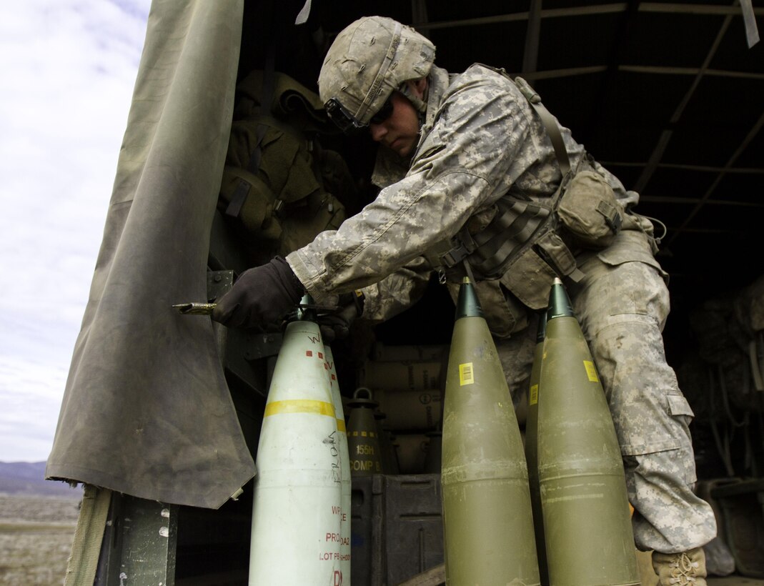 A cannon crew member prepares artillery shells to be fired at the Yakima Training Center, Yakima, Wash., Feb. 24, 2016. Members of the 1st Battalion, 37th Field Artillery Regiment from Joint Base Lewis-McChord, Wash., participated in the training. U.S. Army photo by Sgt. Cody Quinn