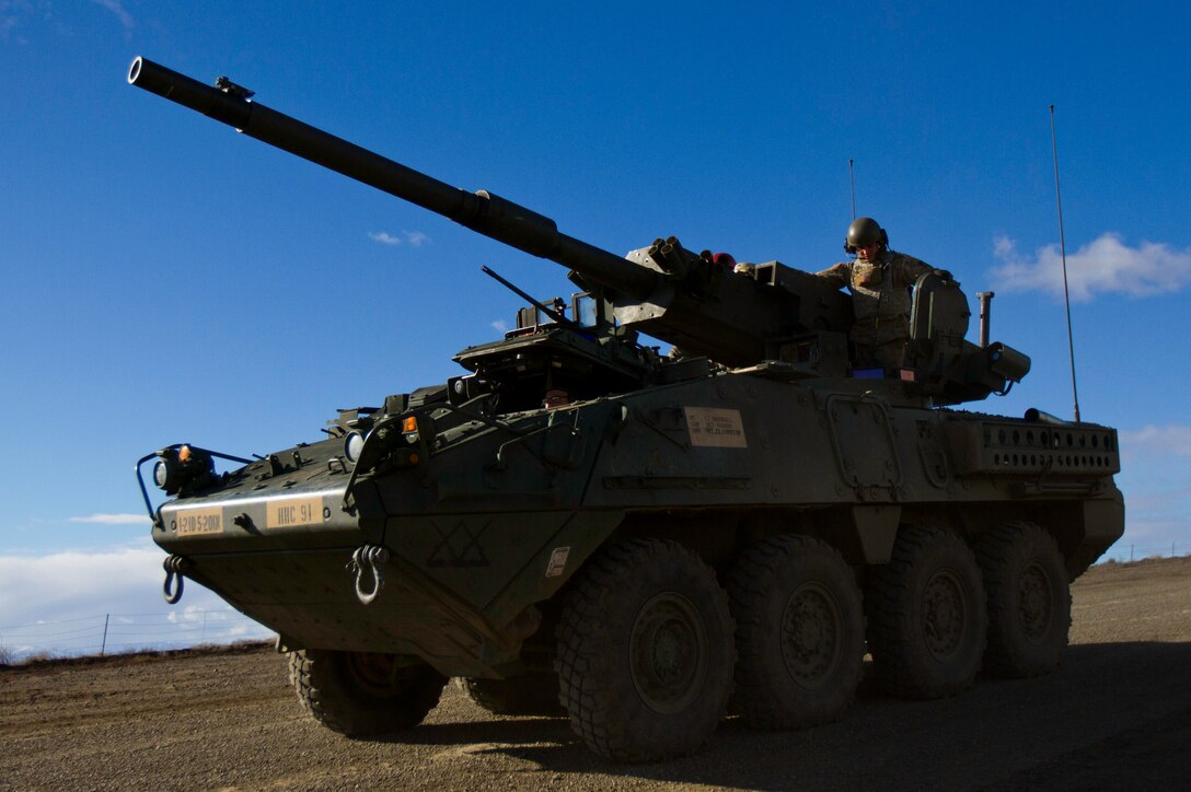 Army Spc. Luc Peterson gives the driver of a Mobile Gun System Stryker variant directions while training at the Yakima Training Center, Yakima, Wash., Feb. 23, 2016. Stryker gunners provide their drivers with additional direction to compensate for limited visibility. Peterson is a gunner with Headquarter and Headquarters Company, 5th Battalion, 20th Infantry Regiment, 1-2 Stryker Brigade Combat Team, 7th Infantry Division, Joint Base Lewis-McChord, Wash. U.S. Army photo by Sgt. Cody Quinn